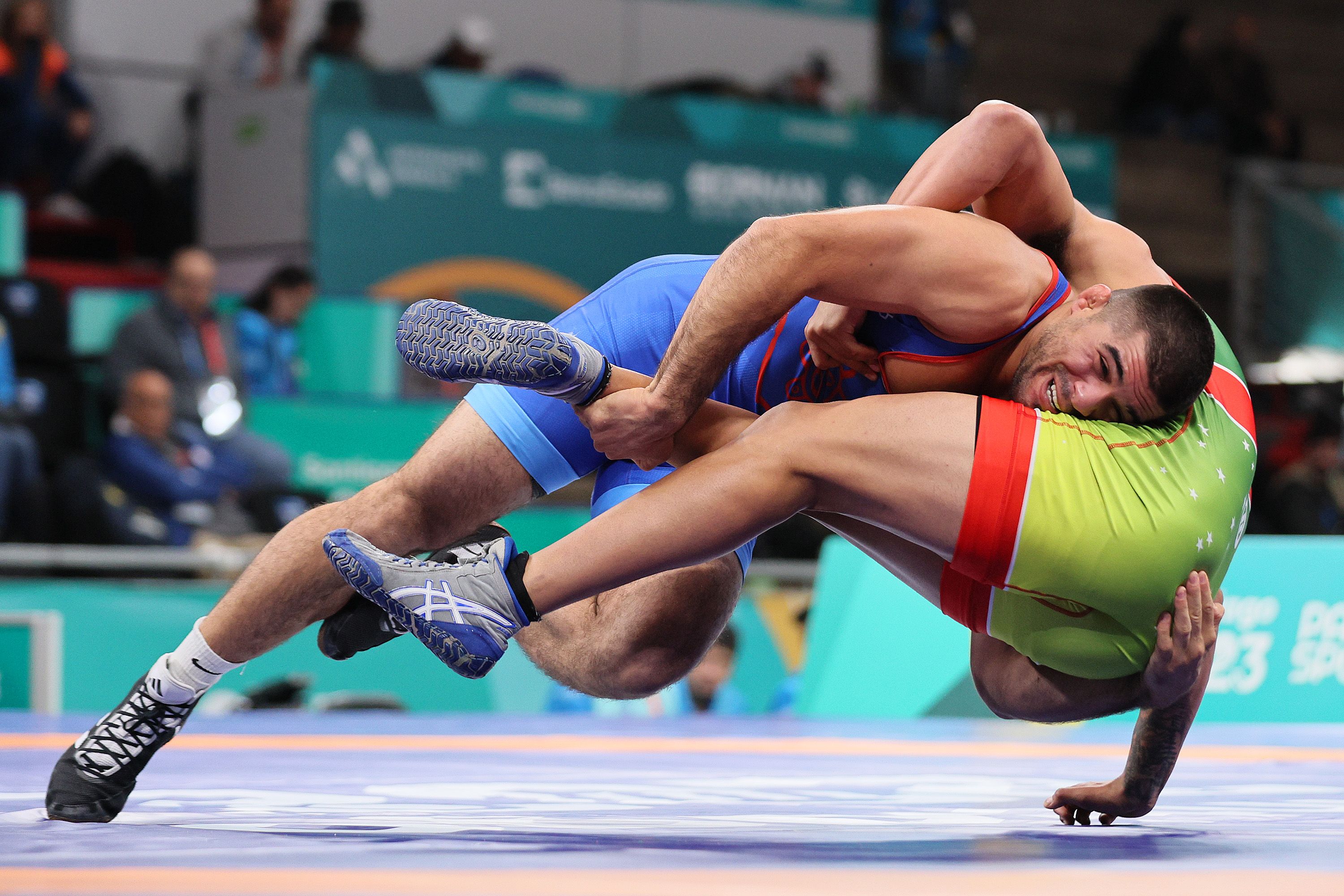 Ethan Ramos of Team Puerto Rico and Guilherme Barros of Team Brazil compete on Wrestling - Men's Freestyle 86kg Quarterfinals at Centro de Entrenamiento Olimpico on Day 13 of Santiago 2023 Pan Am Games on November 02, 2023 in Santiago, Chile. (Photo by Andy Lyons/Getty Images)