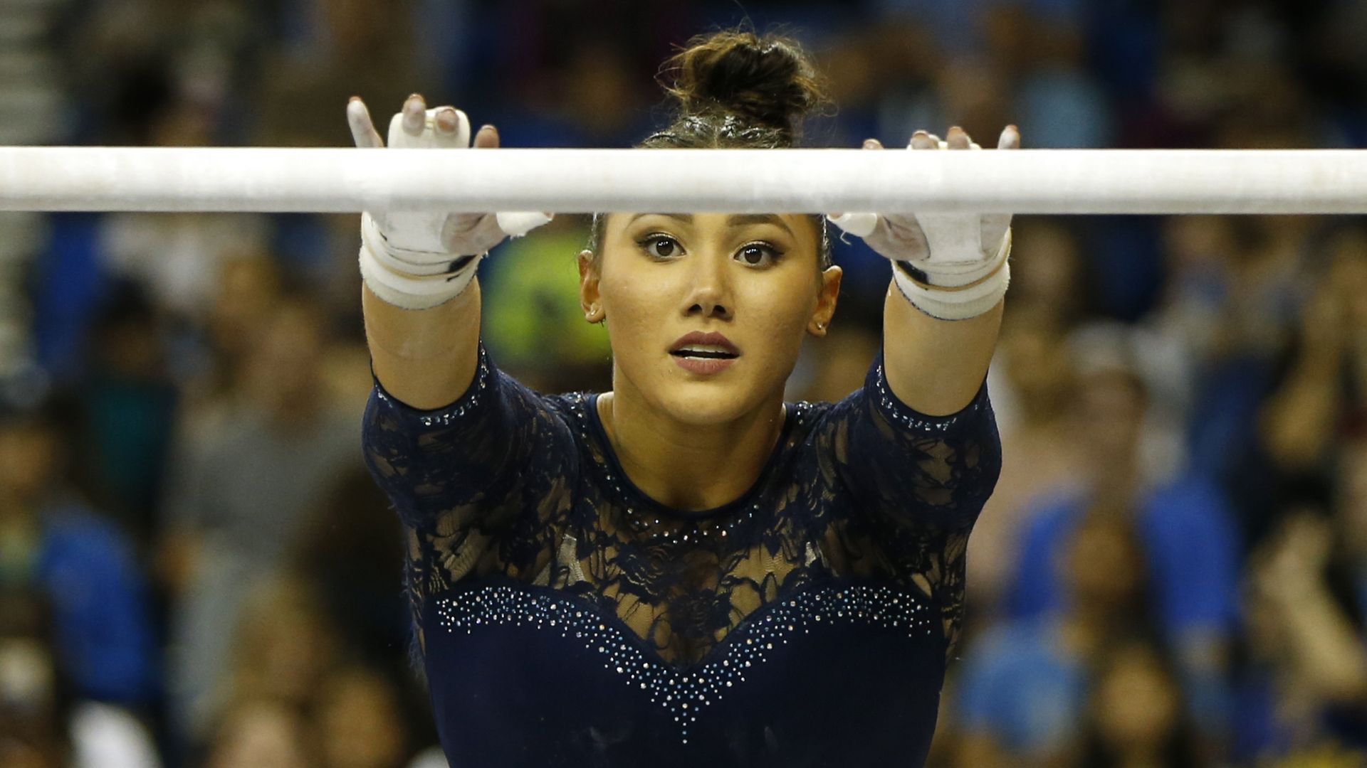 UCLA gymnast competing on the bars