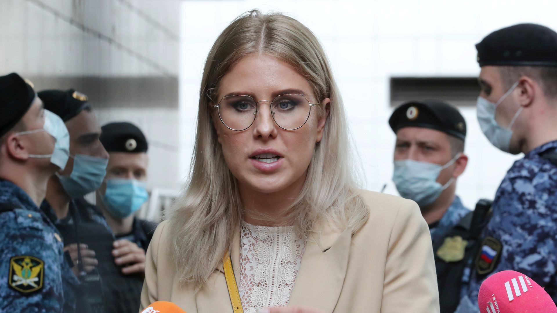 Lyubov Sobol is seen outside Moscow's Preobrazhensky District Court after her sentencing on Aug. 3, speaking into a mic