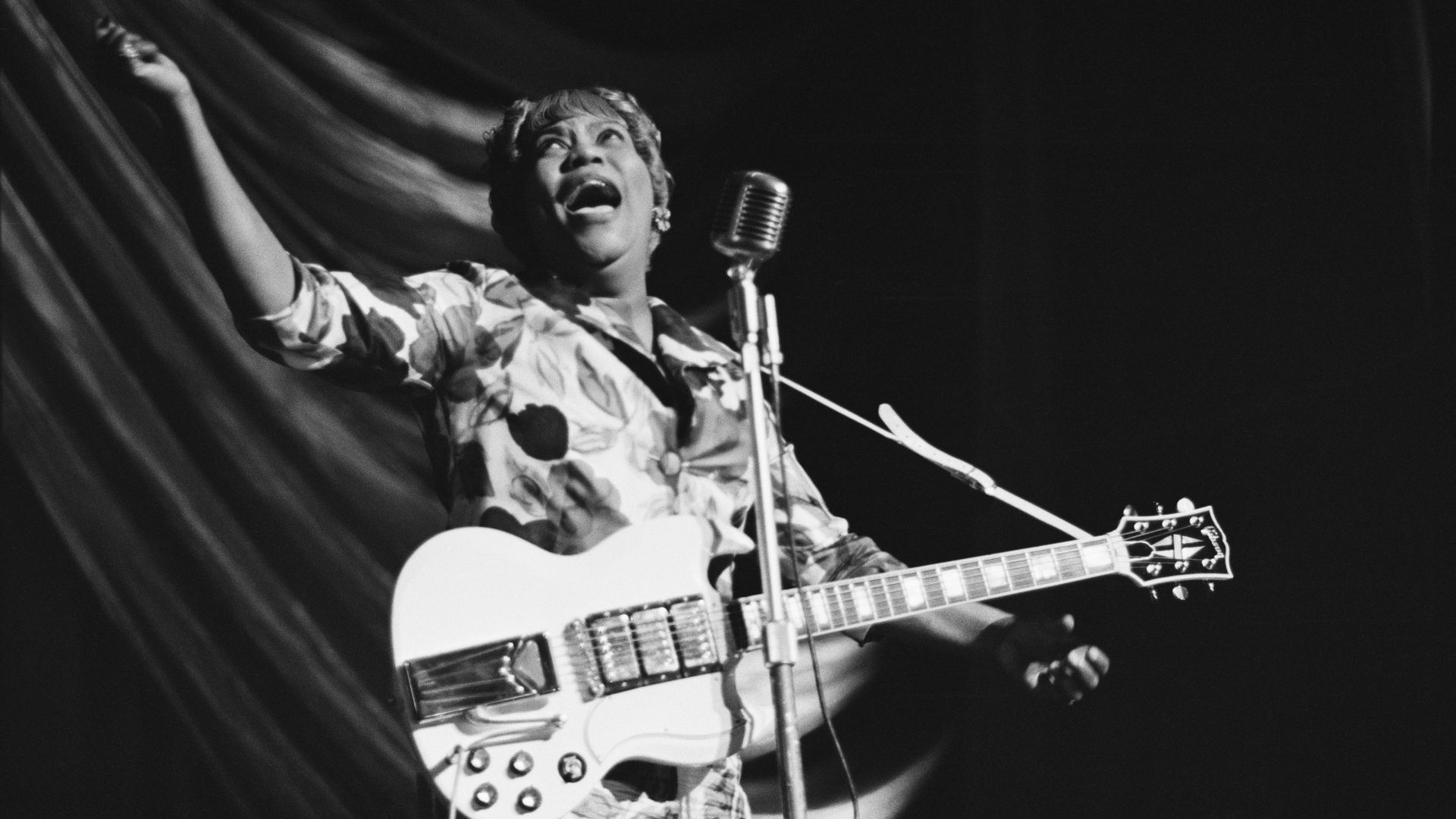 American gospel singer Sister Rosetta Tharpe (1915 - 1973) performs at a Blues and Gospel Caravan tour in the UK, 1964. 