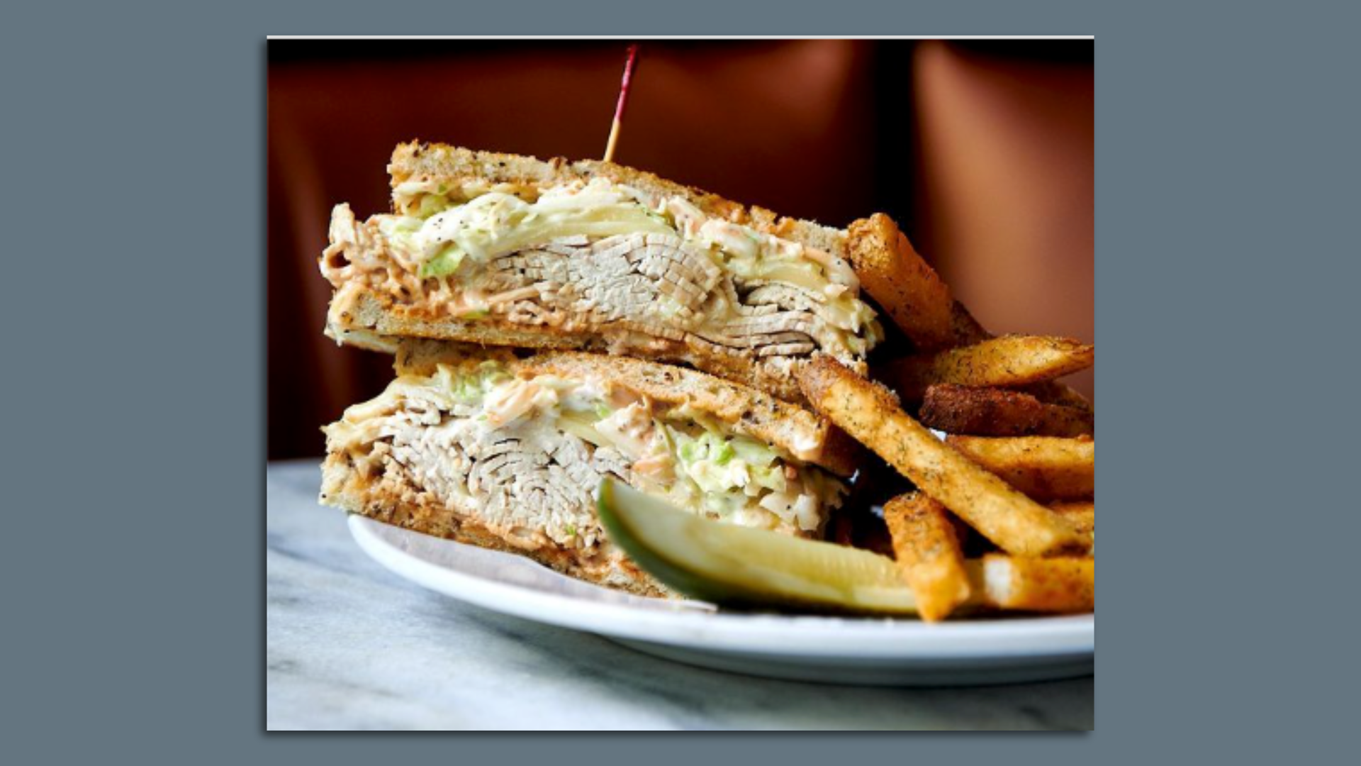 A savory turkey sandwich with fries