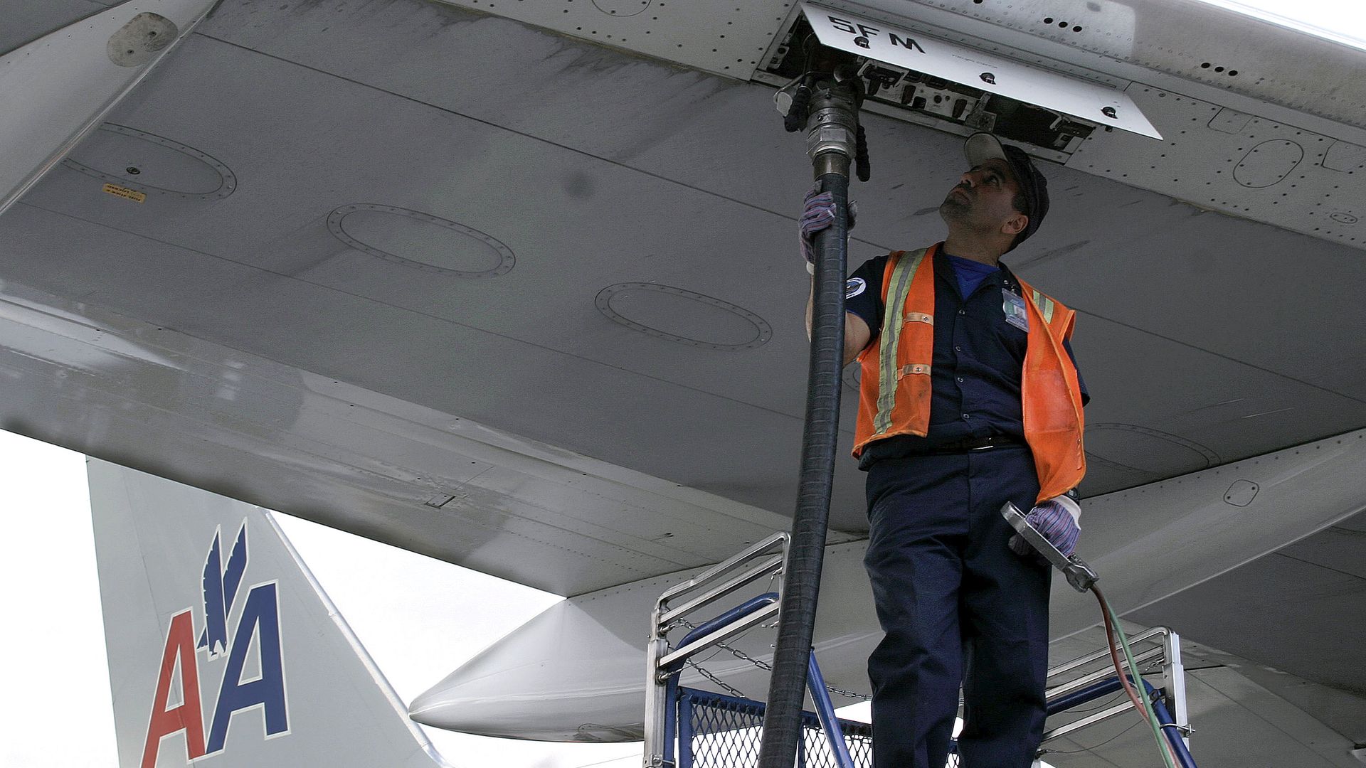 Worker fueling airplane 