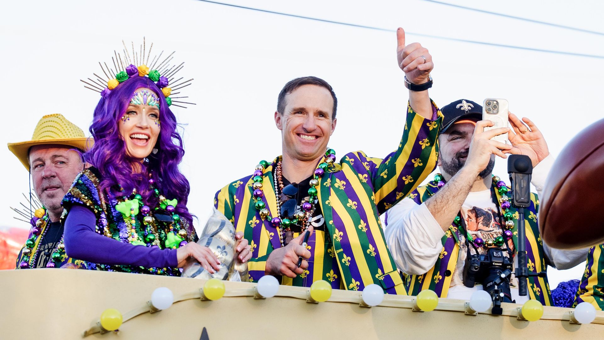 Photo shows Drew Brees and his wife in Mardi Gras costumes on a float.