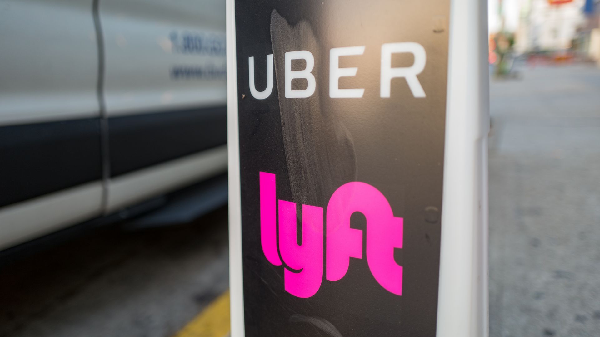 A sign with Uber and Lyft on it