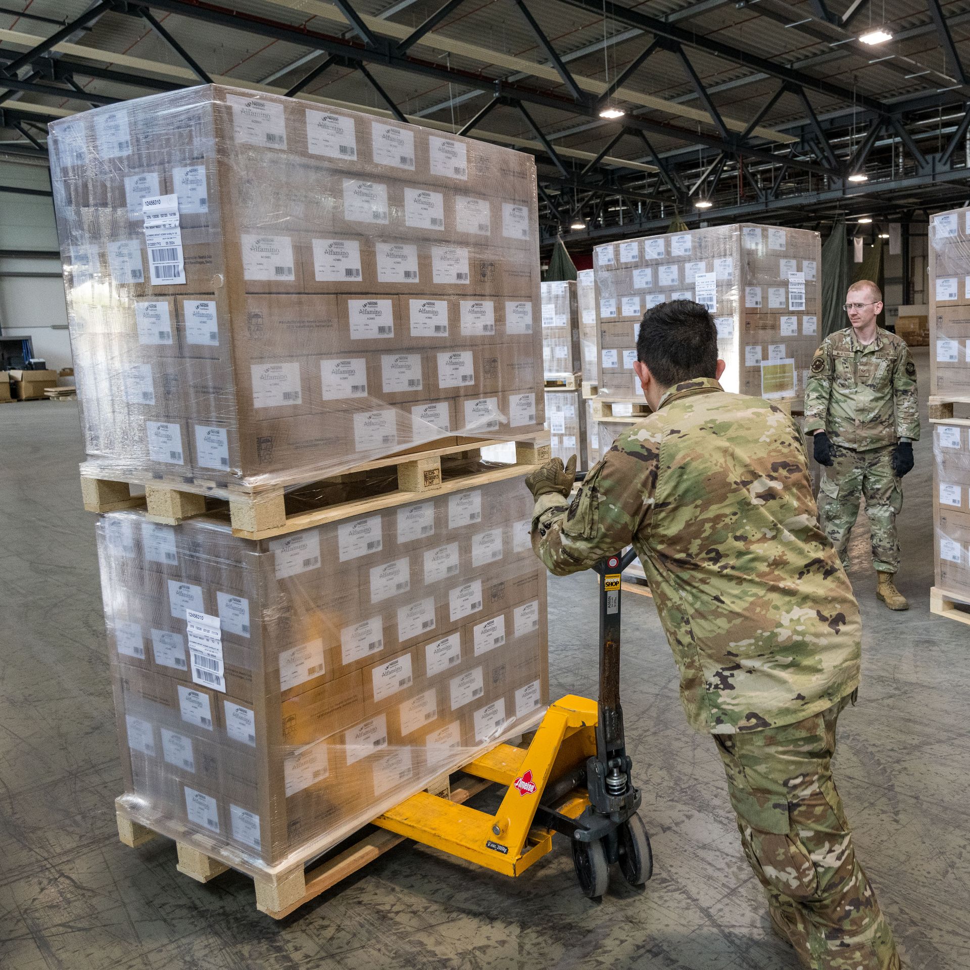 U.S. airmen load pallets with baby formula 