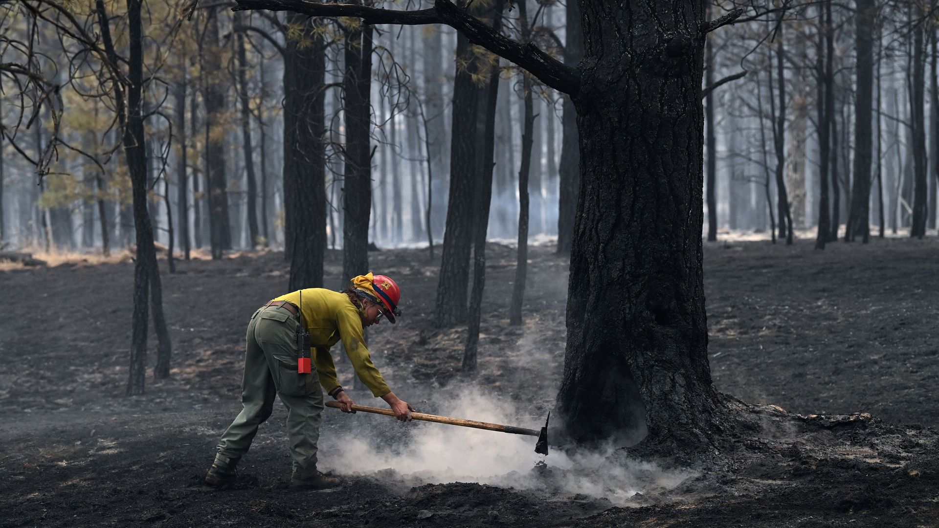 A firefighter putting out a hotspot from a wildfire near Mora, New Mexico, on May 13.