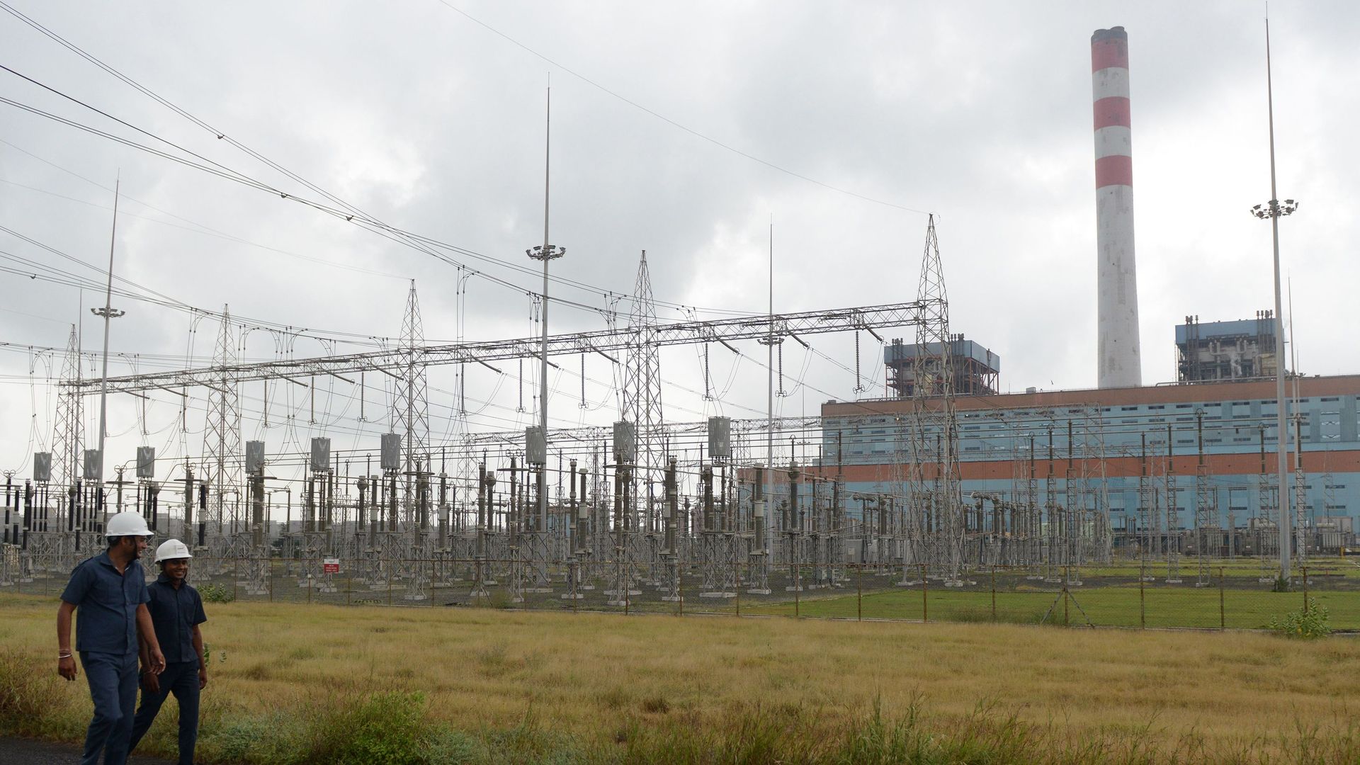 a coal-fired power plant behind an open field