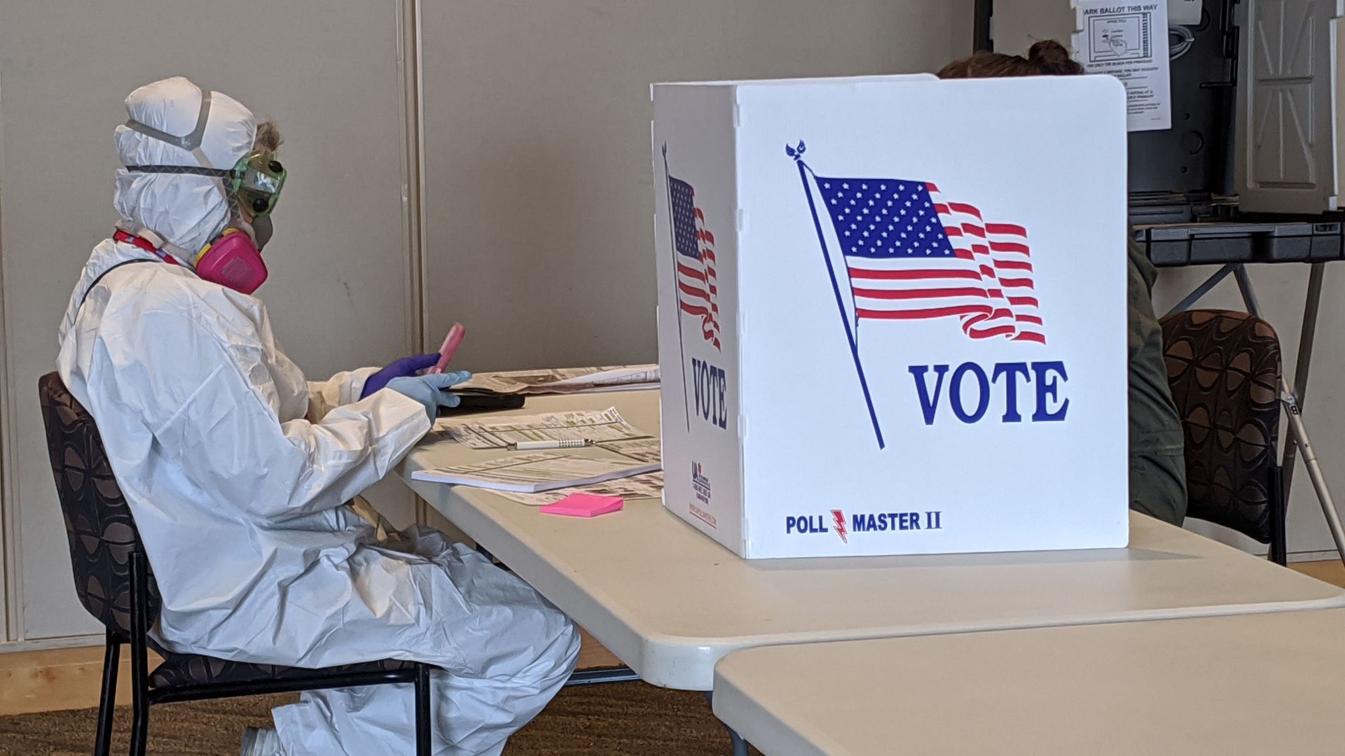 A poll worker in a hazmat suit.