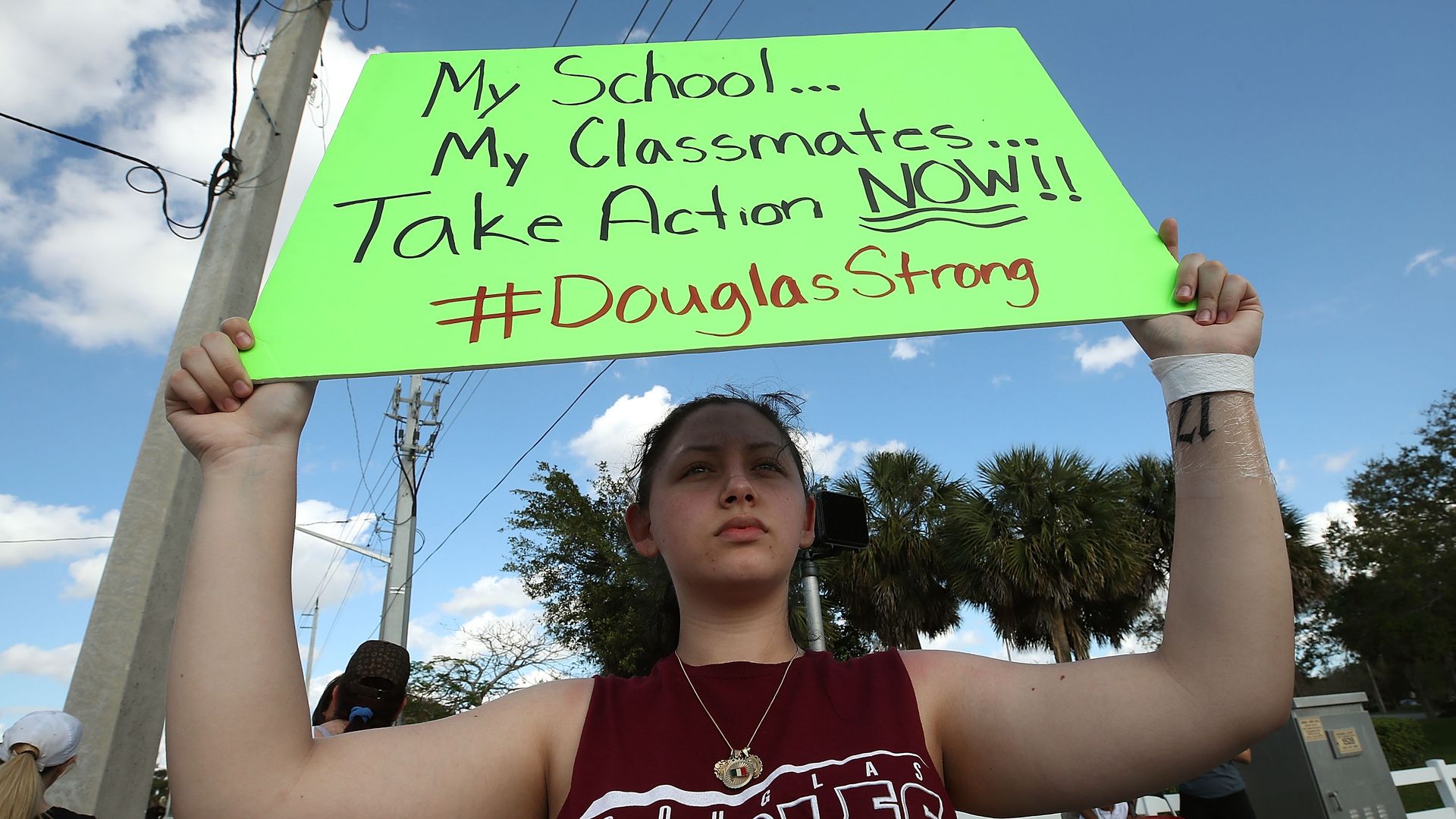 Student Angelia Lazo holds up a sign