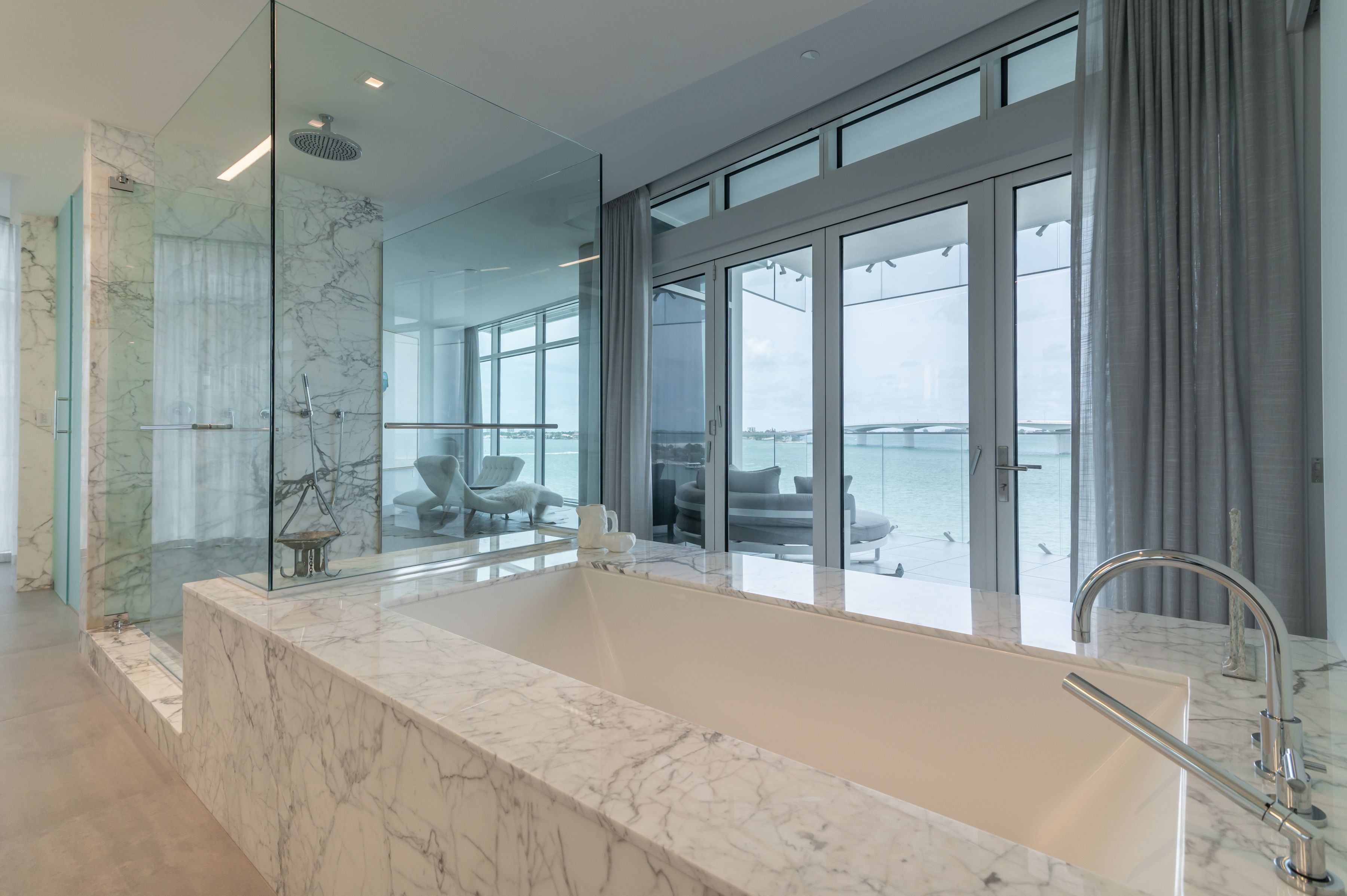 big marble tub with a view of the terrace and skyway