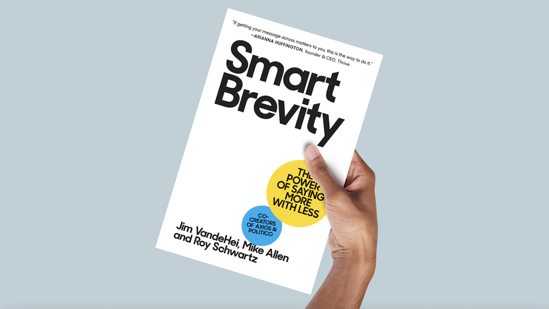 an illustration of a hand holding "Smart Brevity," the book