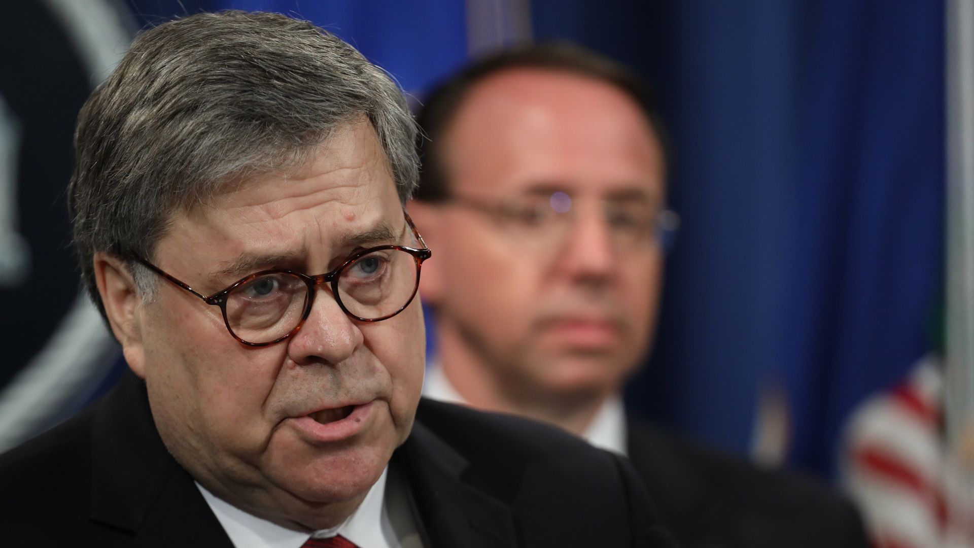 In this image, Barr speaks to a crowd