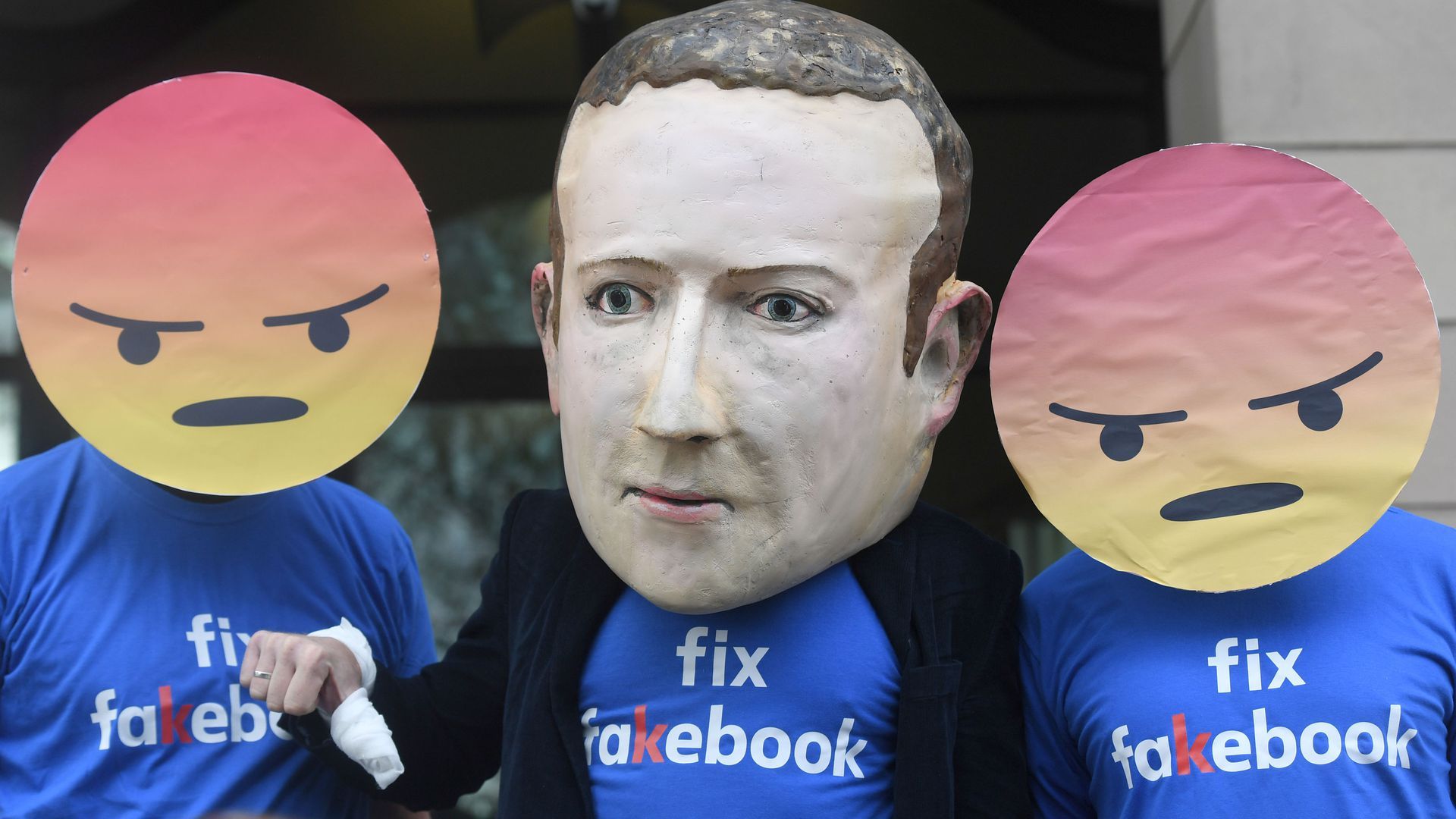 Giant puppet head of Mark Zuckerberg worn by a protester in London