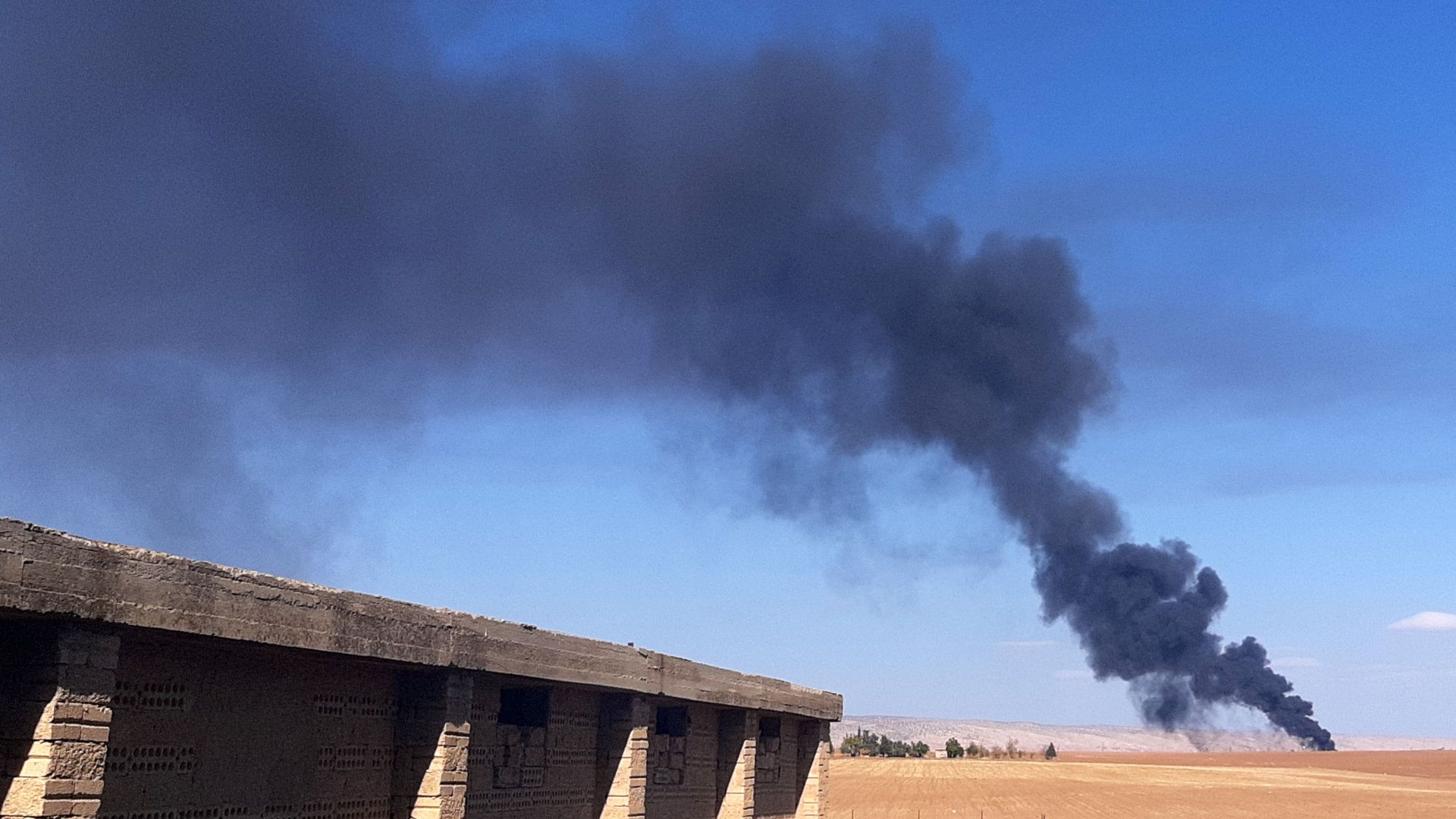 Smoke plumes rise in a field following reported Turkish drone strikes near the town of al-Qahtaniyah in Syria's northeastern Hasakah province, close to the border with Turkey, on Nov. 23.