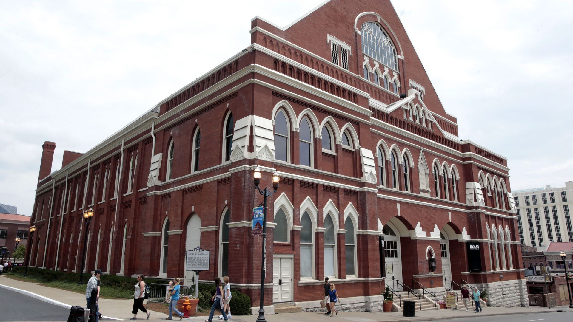 Exterior of the ryman auditorium with pedestrians walking by