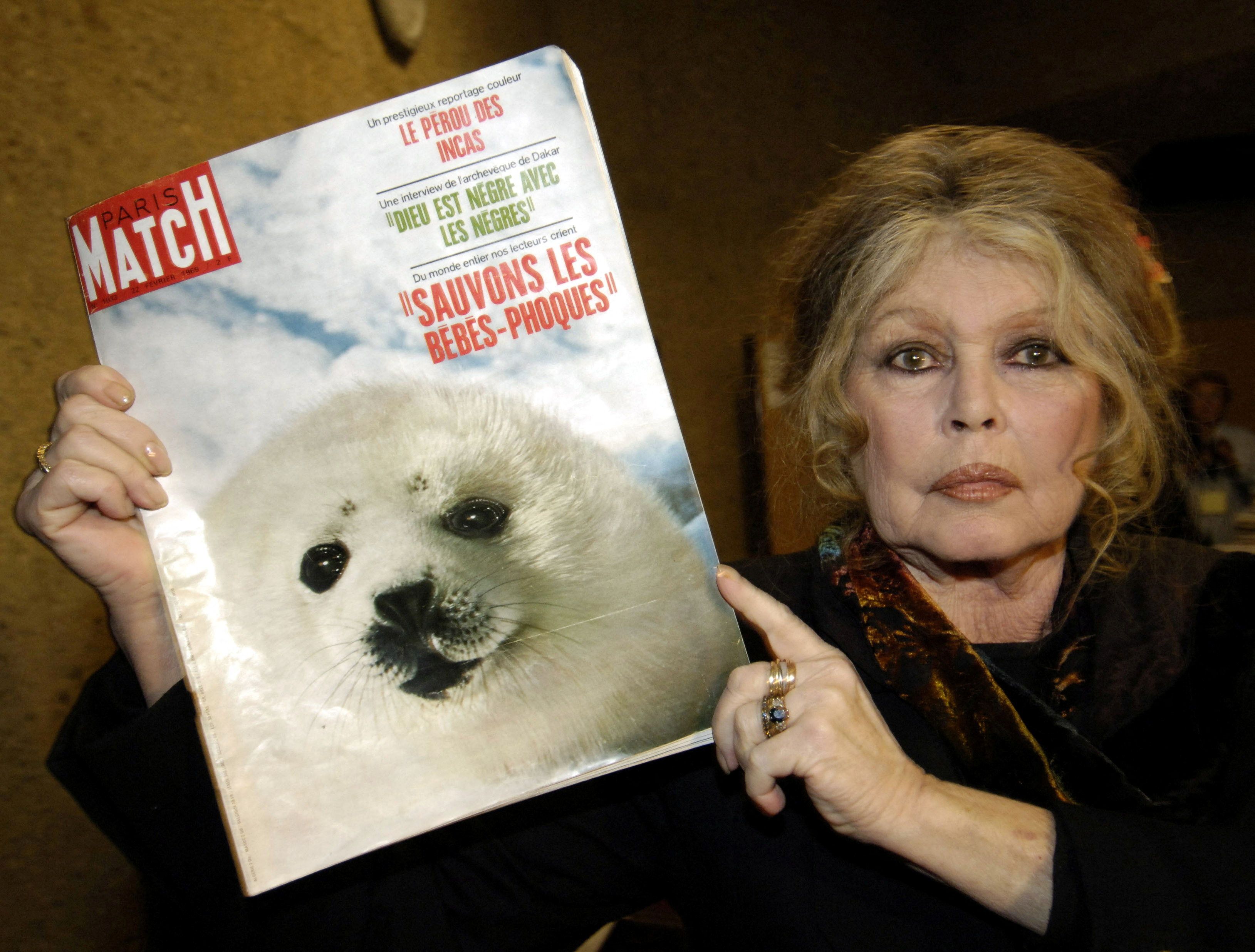 Brigitte Bardot displays a 1969 copy of Paris Match in Geneva in 2005 in an appeal to stop the slaughter of seals. Photo: Reuters