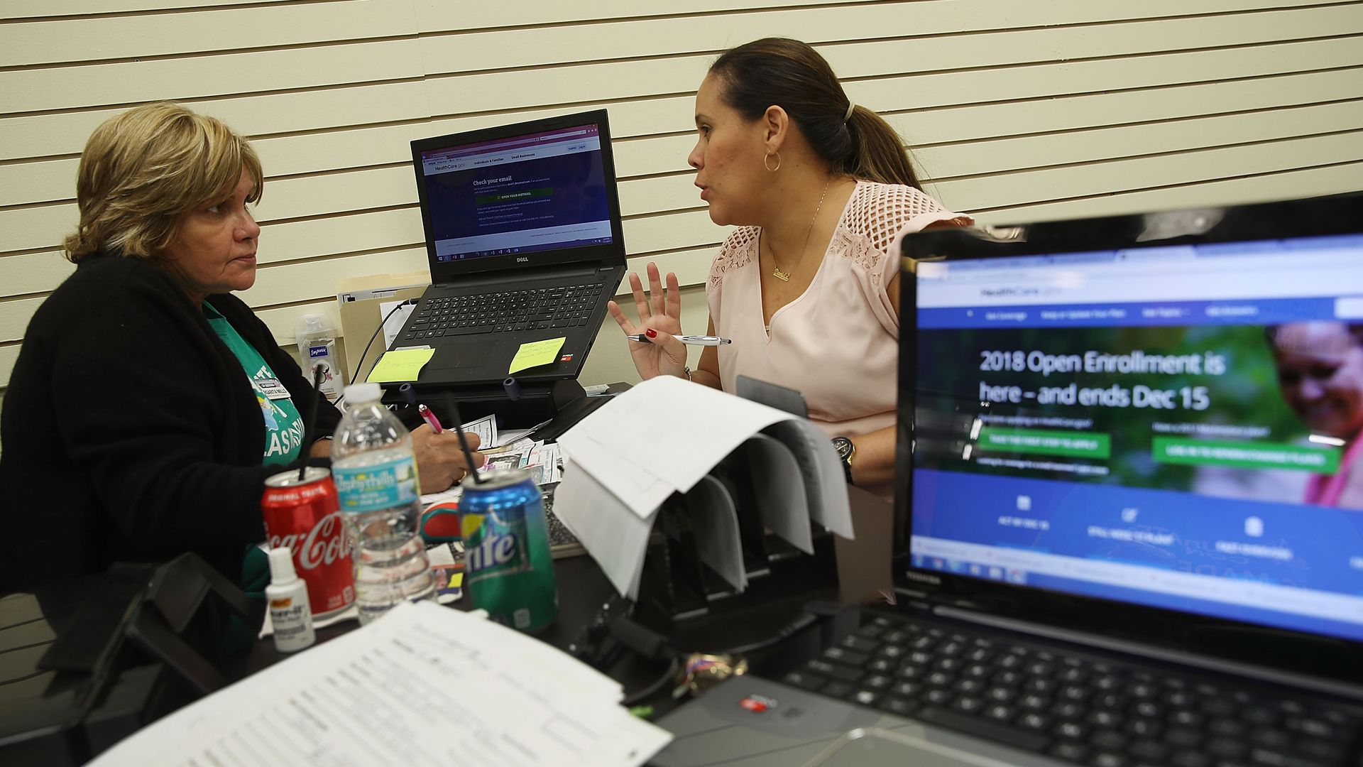 An insurance agent helps a person sign up for an ACA health plan.