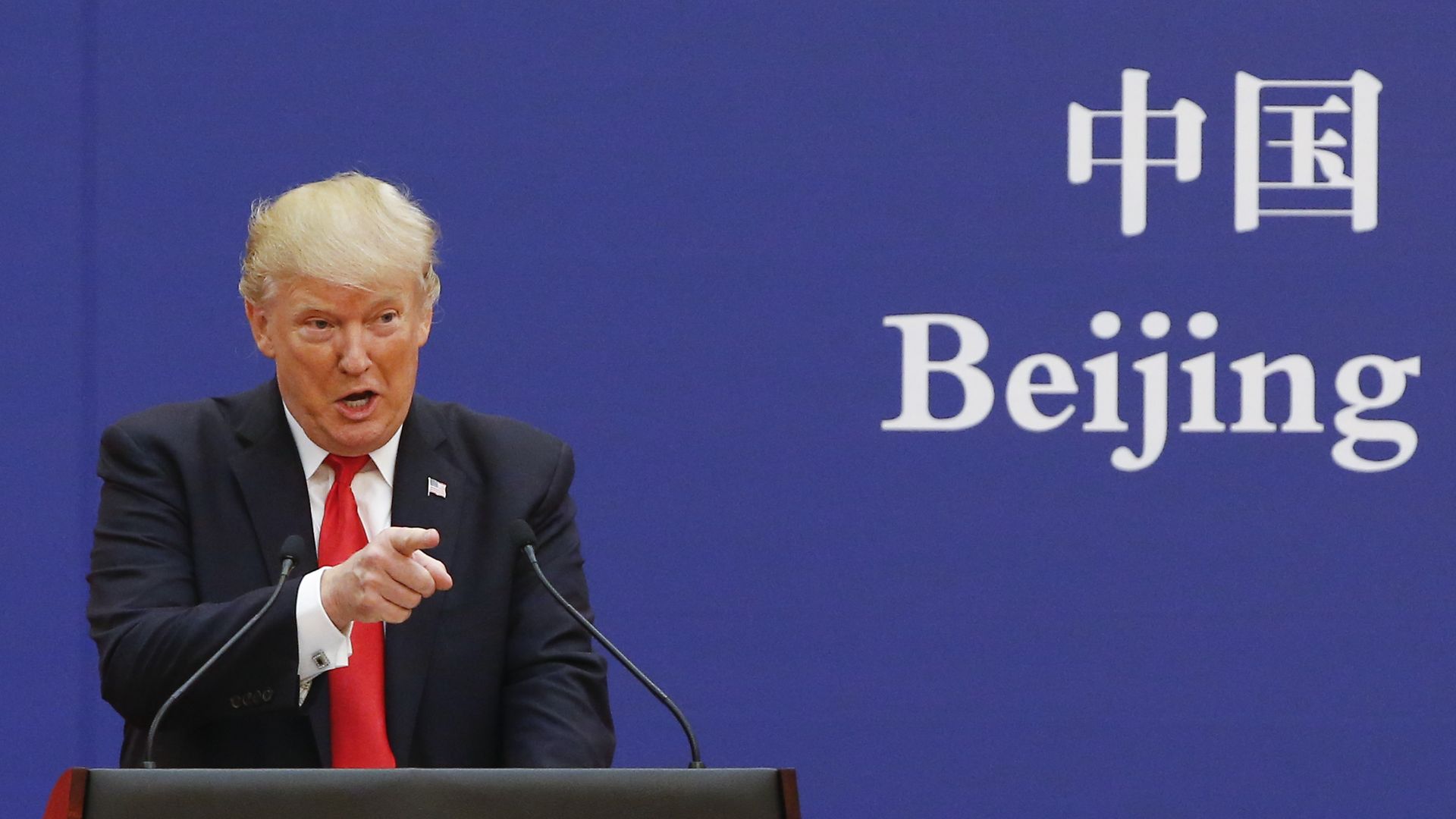 Trump behind a podium in Beijing. 