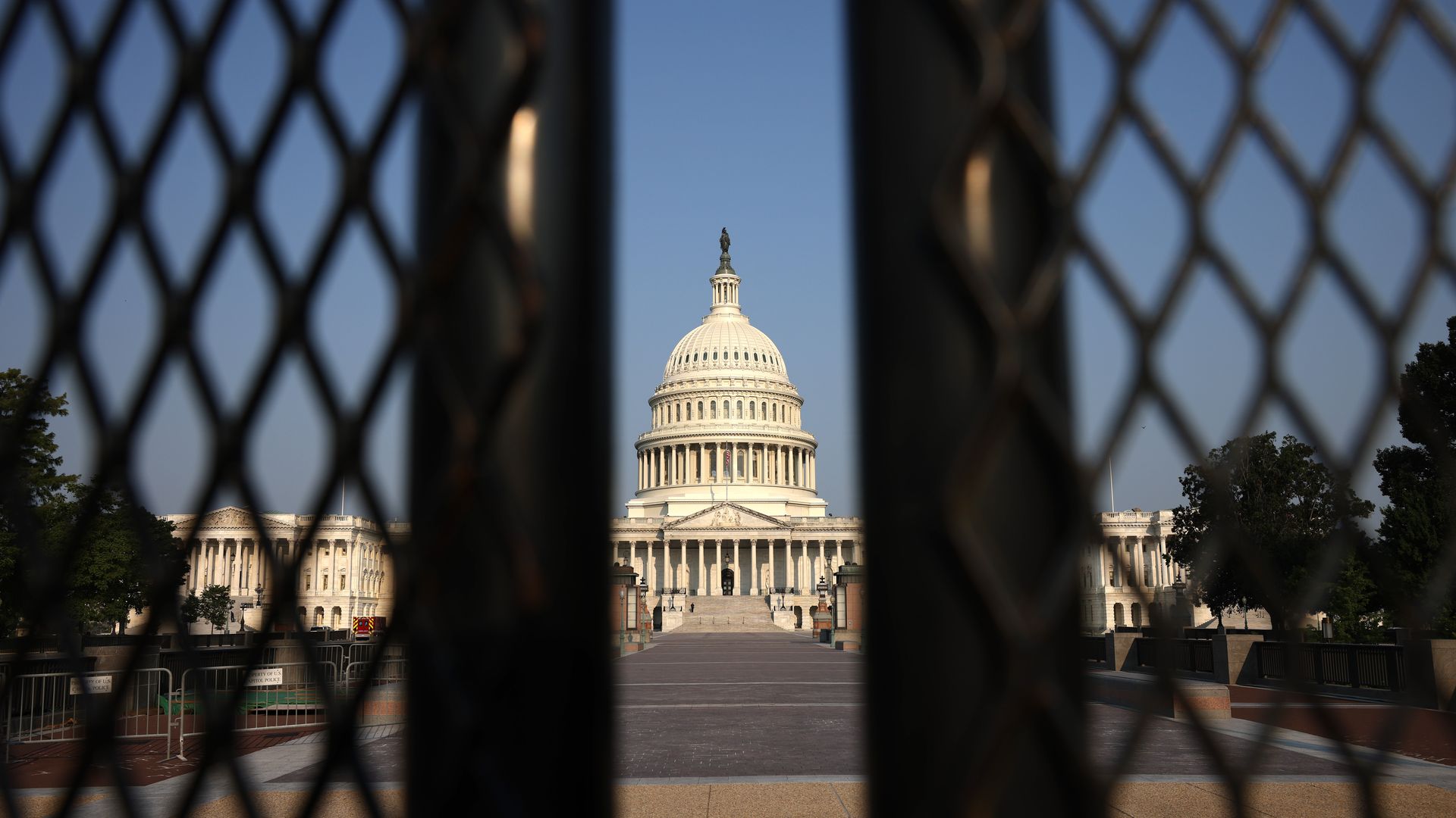 Picture of the Capitol building taken in between fences