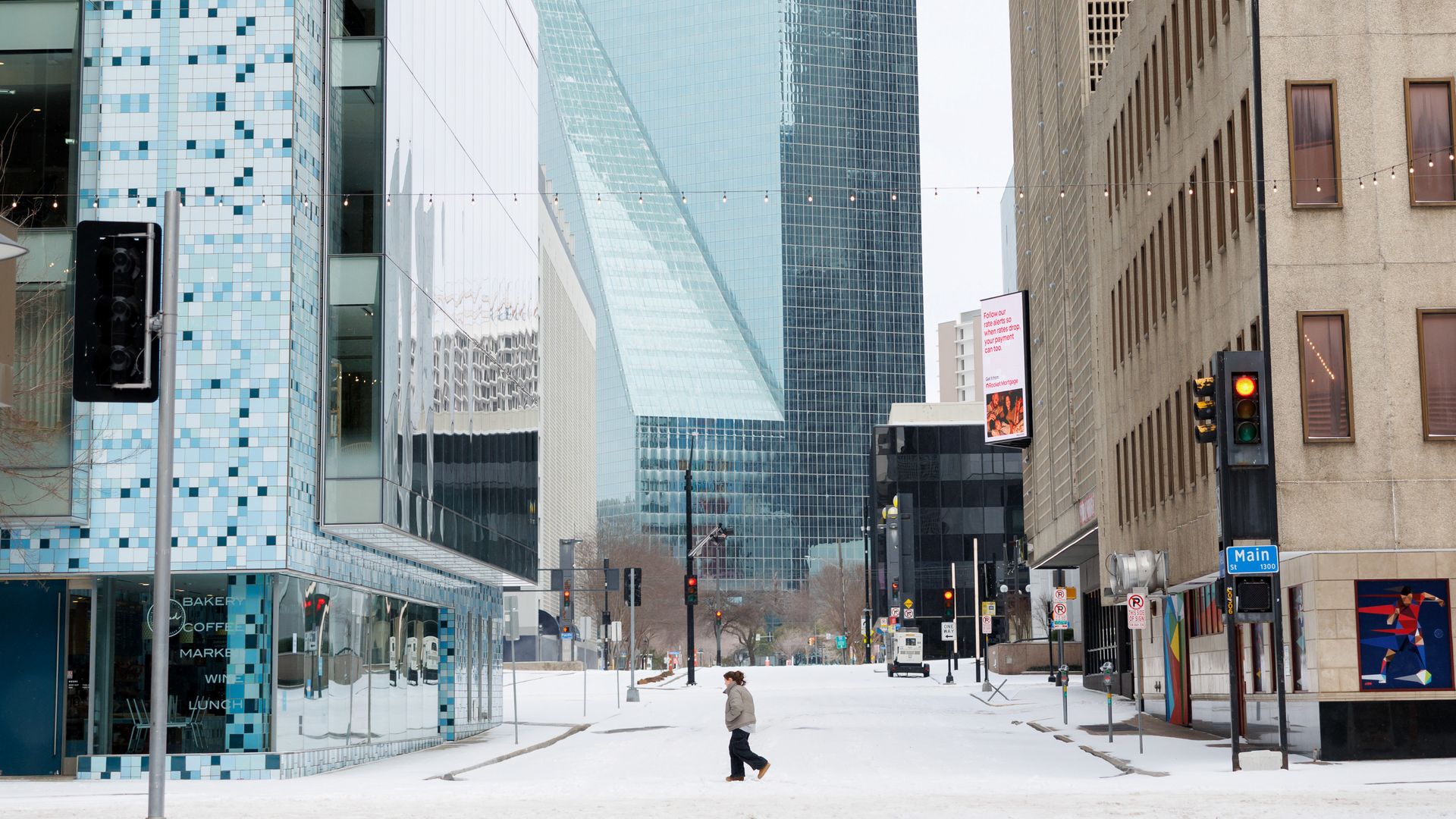 A photo of a person walking in a snowy downtown Dallas