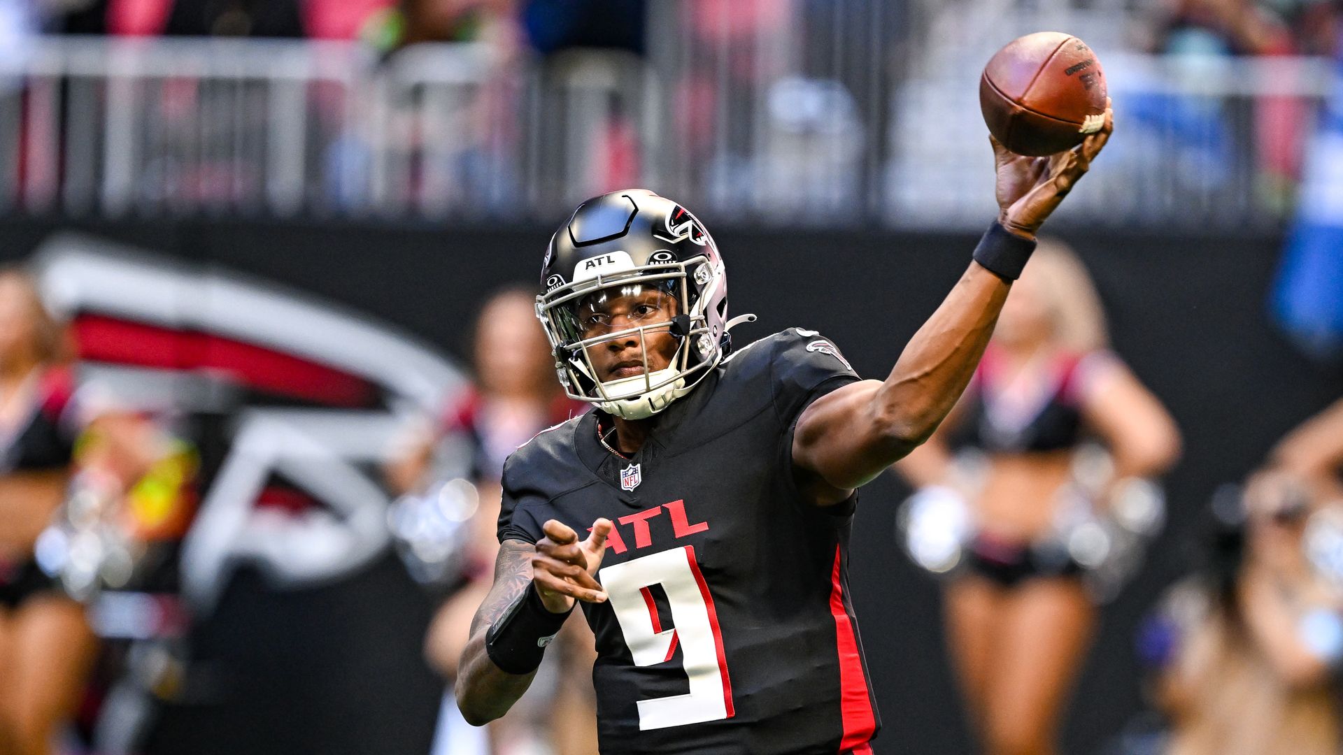 A man in a football uniform throws the ball