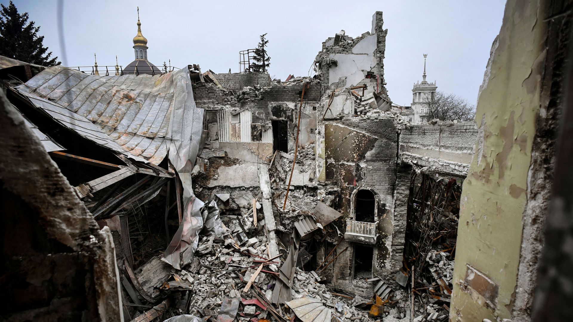 Photo of a caved in building with rubble scattered everywhere