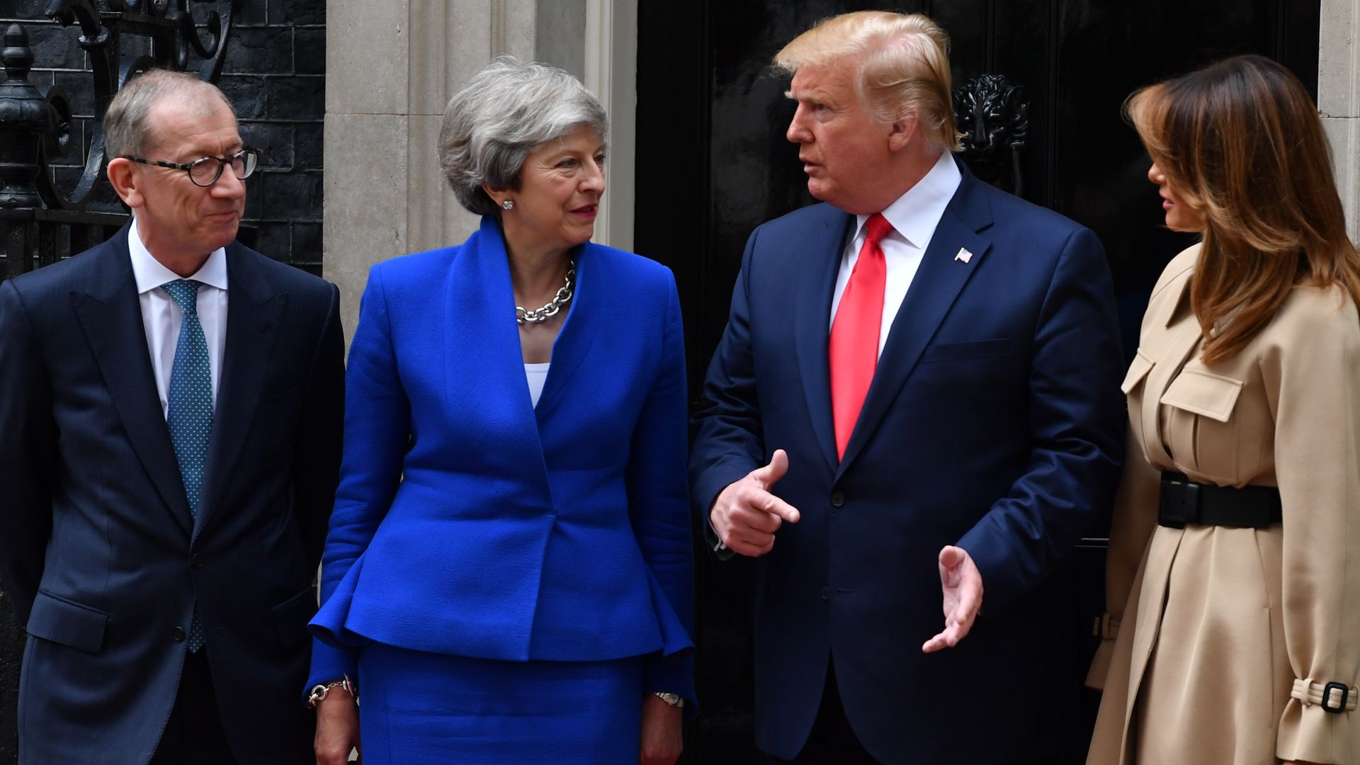 In this image, May and Trump talk while standing next to their spouses in front of Downing Street.