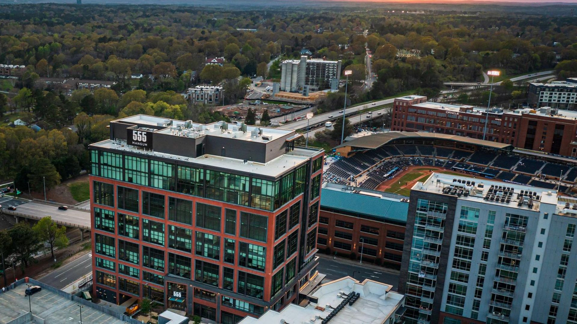 A drone shot of the 555 Mangum office building in downtown Durham, which overlooks the Durham Bulls Athletic Park