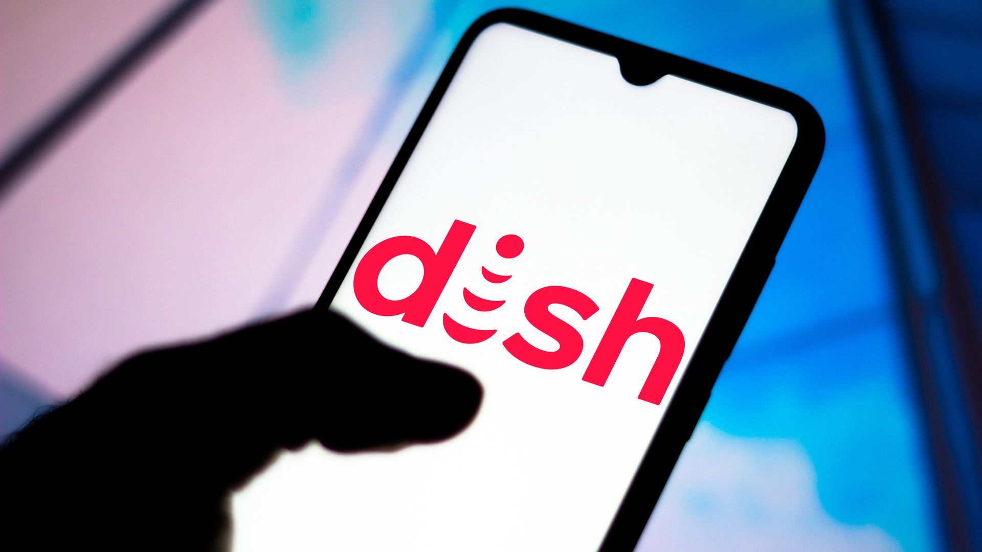 A photo illustration of the Dish Network logo on a smartphone