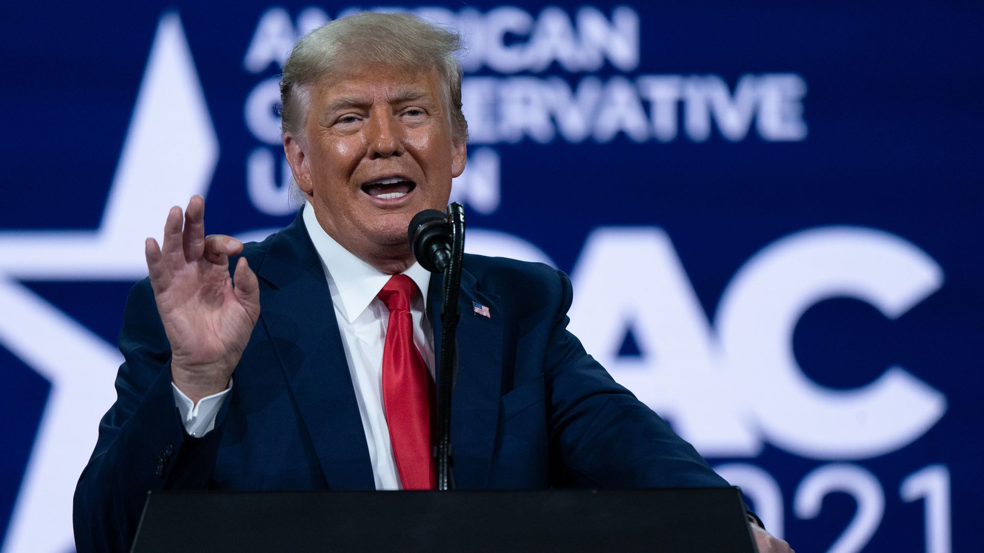 Photo of Donald Trump speaking and gesturing with one hand