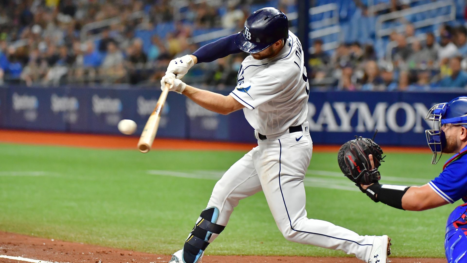 Brandon Lowe of the Tampa Bay Rays swings to hit an RBI off of Alek Manoah of the Toronto Blue Jays.
