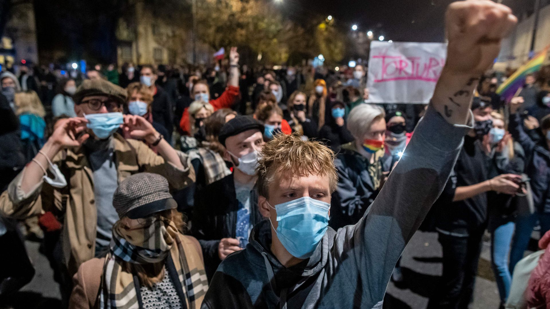Photo of a protester raising their fist amid a crowd of hundreds protesting a near-total abortion ban