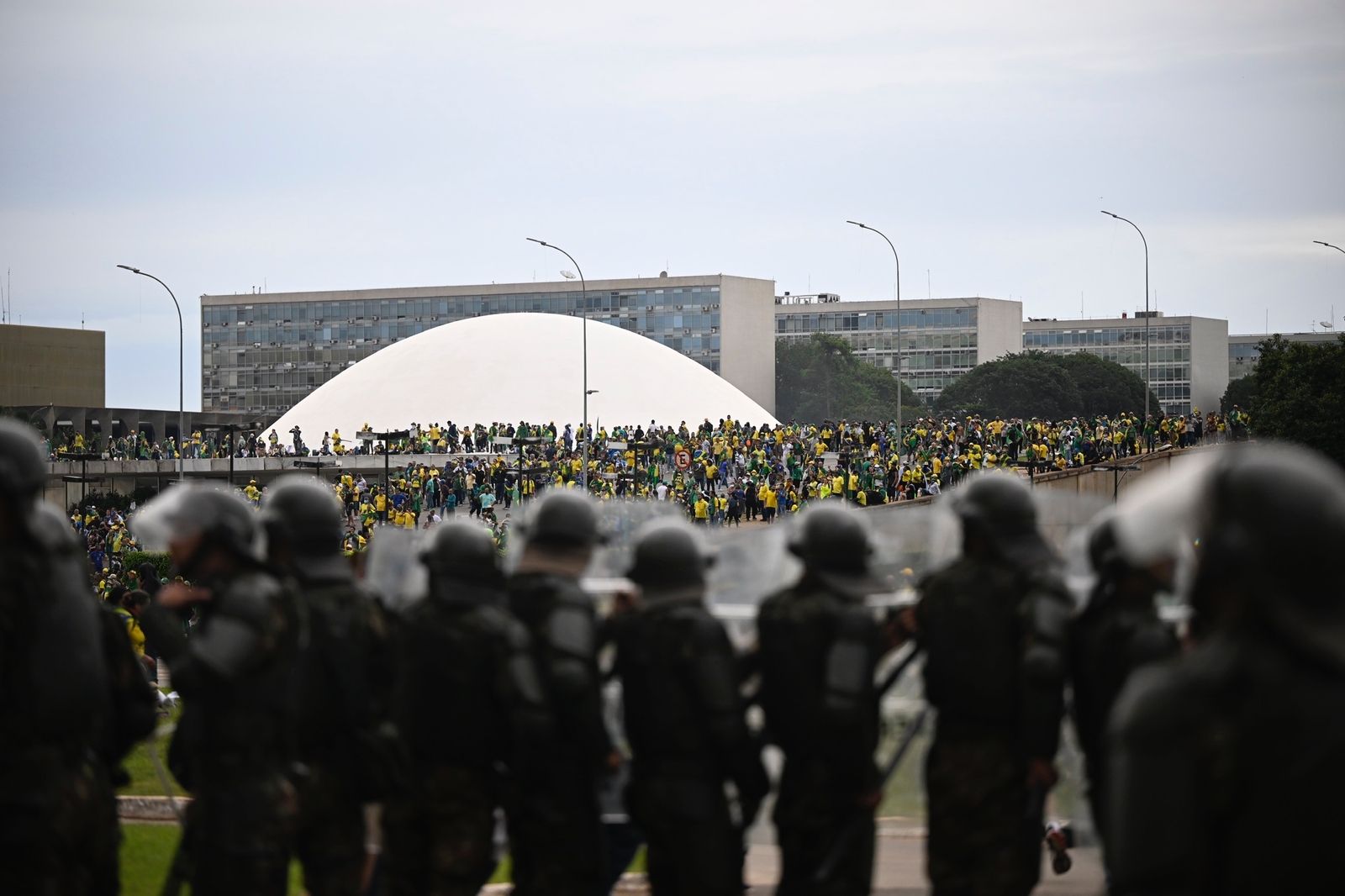 A line of police before a crowd of supporters near the National Congress in Brasilia on Jan. 8.