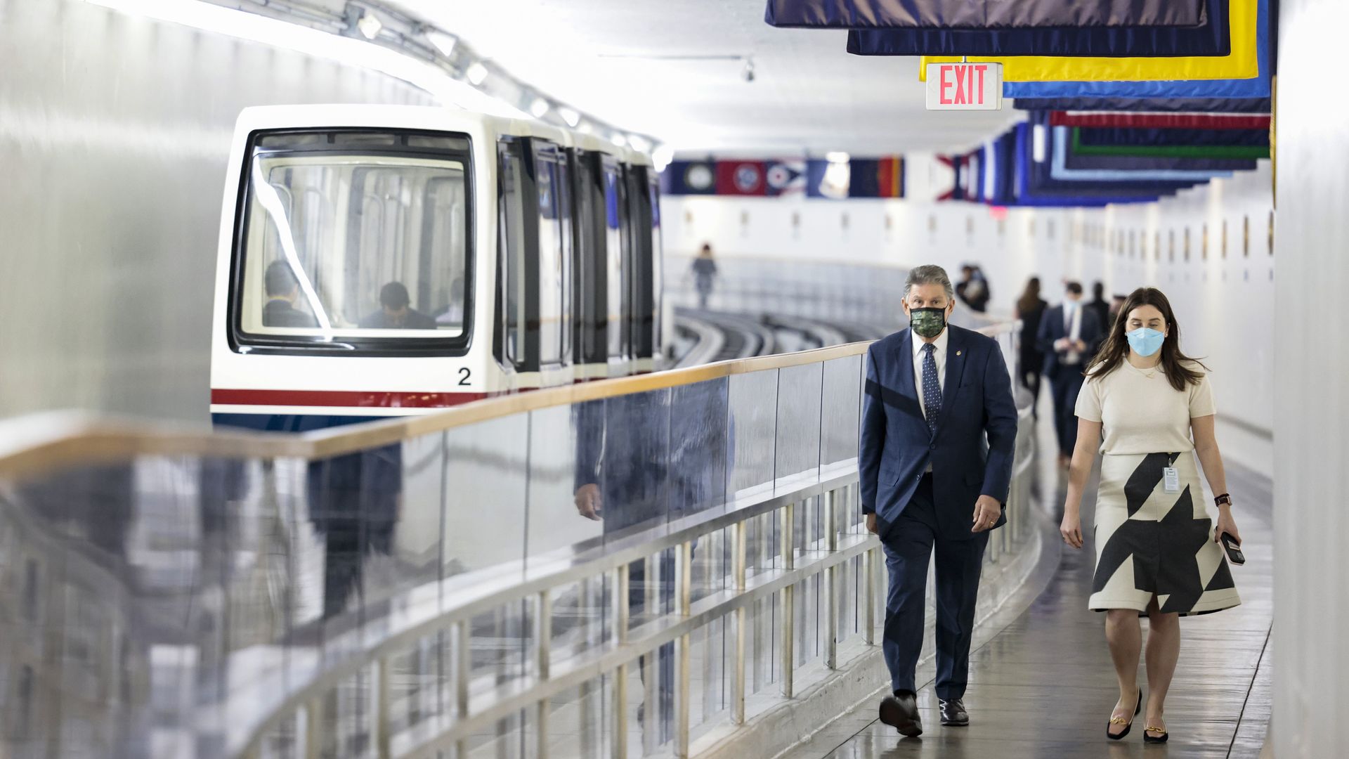 Sen. Joe Manchin is seen walking alongside the Senate subway.