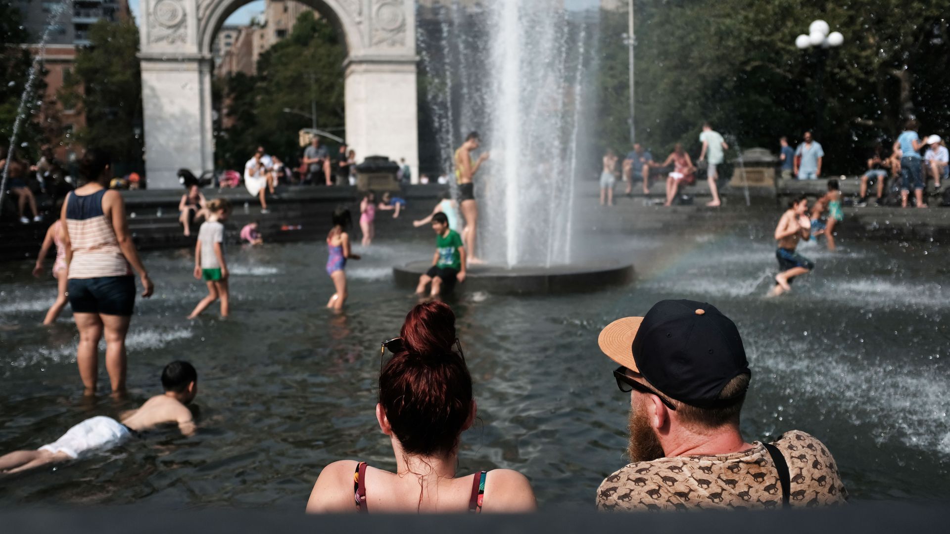 People try and stay cool in the fountain in Washington Square Park during the start of heat wave across the U.S. on July 19.