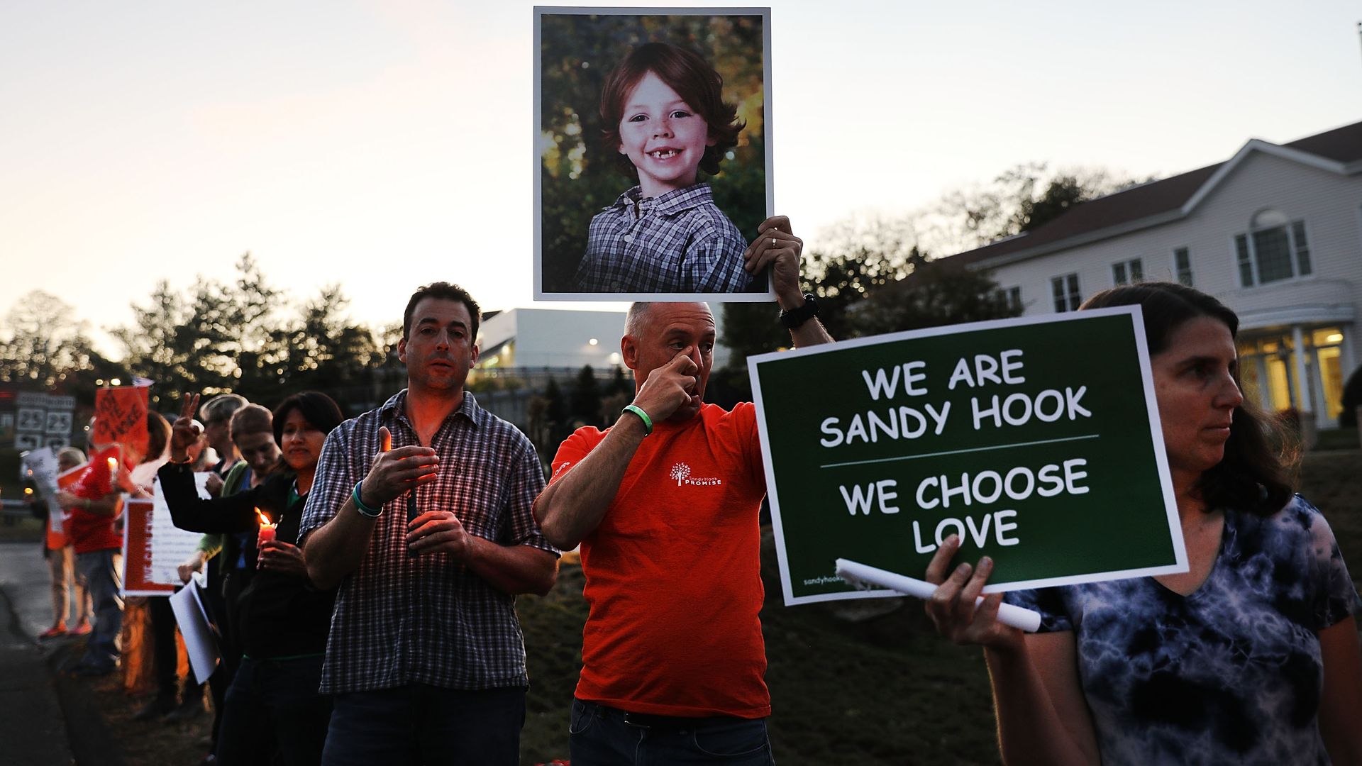 Mark Barden holds up a picture of his son Daniel who was killed in the Sandy Hook masracre during a vigil