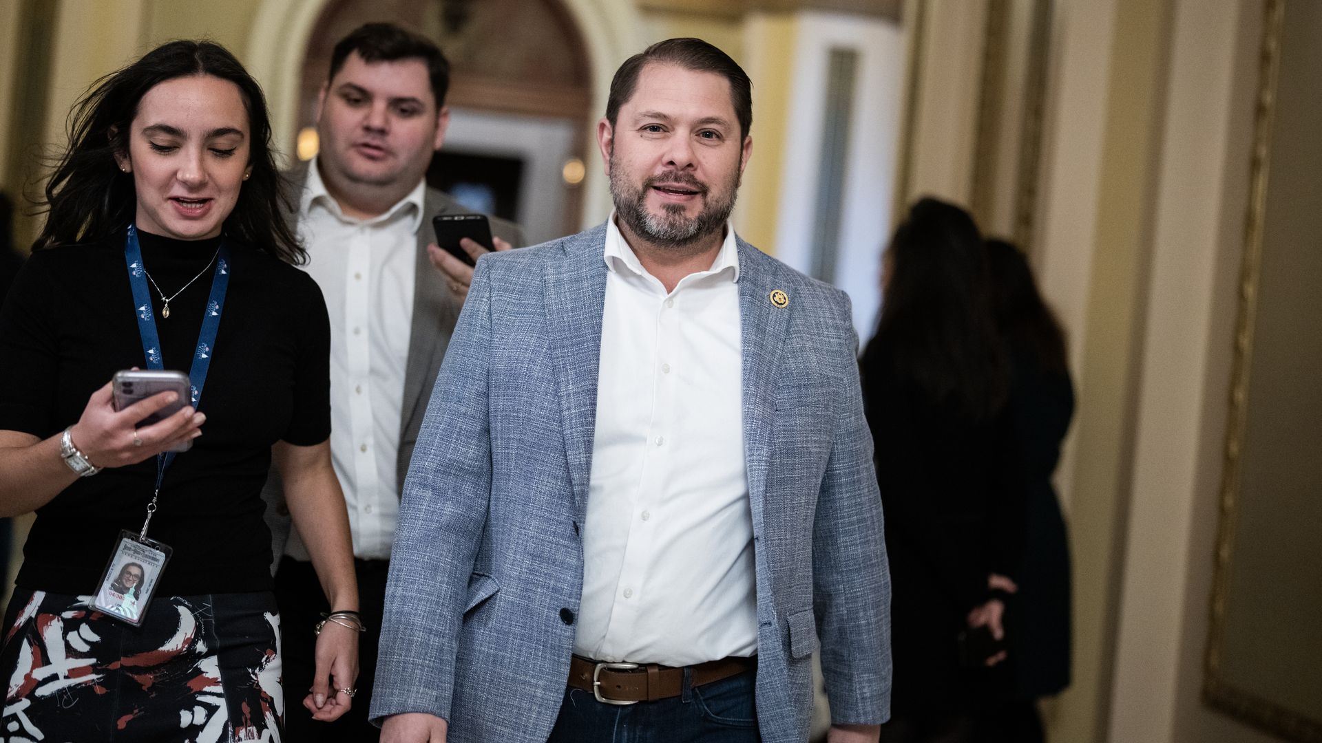 A man walking down a hallway.