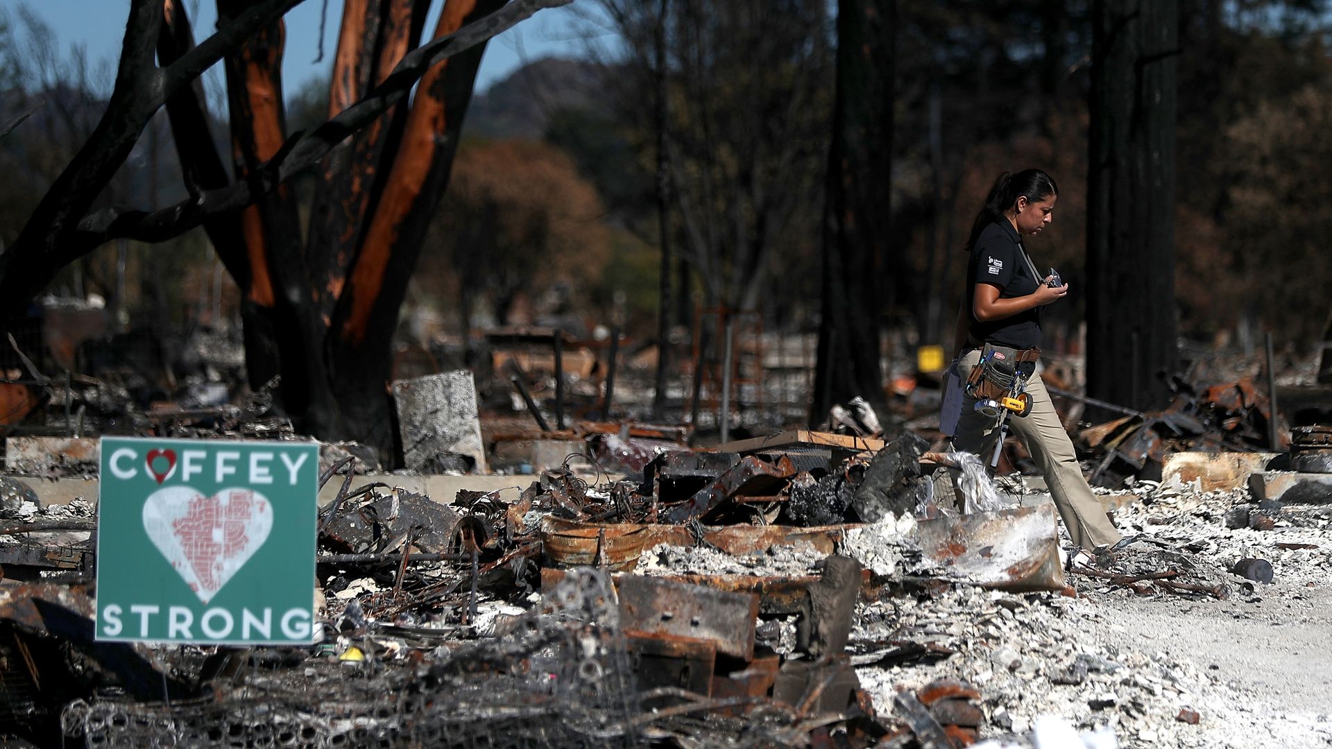 An insurance adjuster walks through a Coffey Park home that was destroyed by the Tubbs Fire on October 23, 2017 in Santa Rosa, California.
