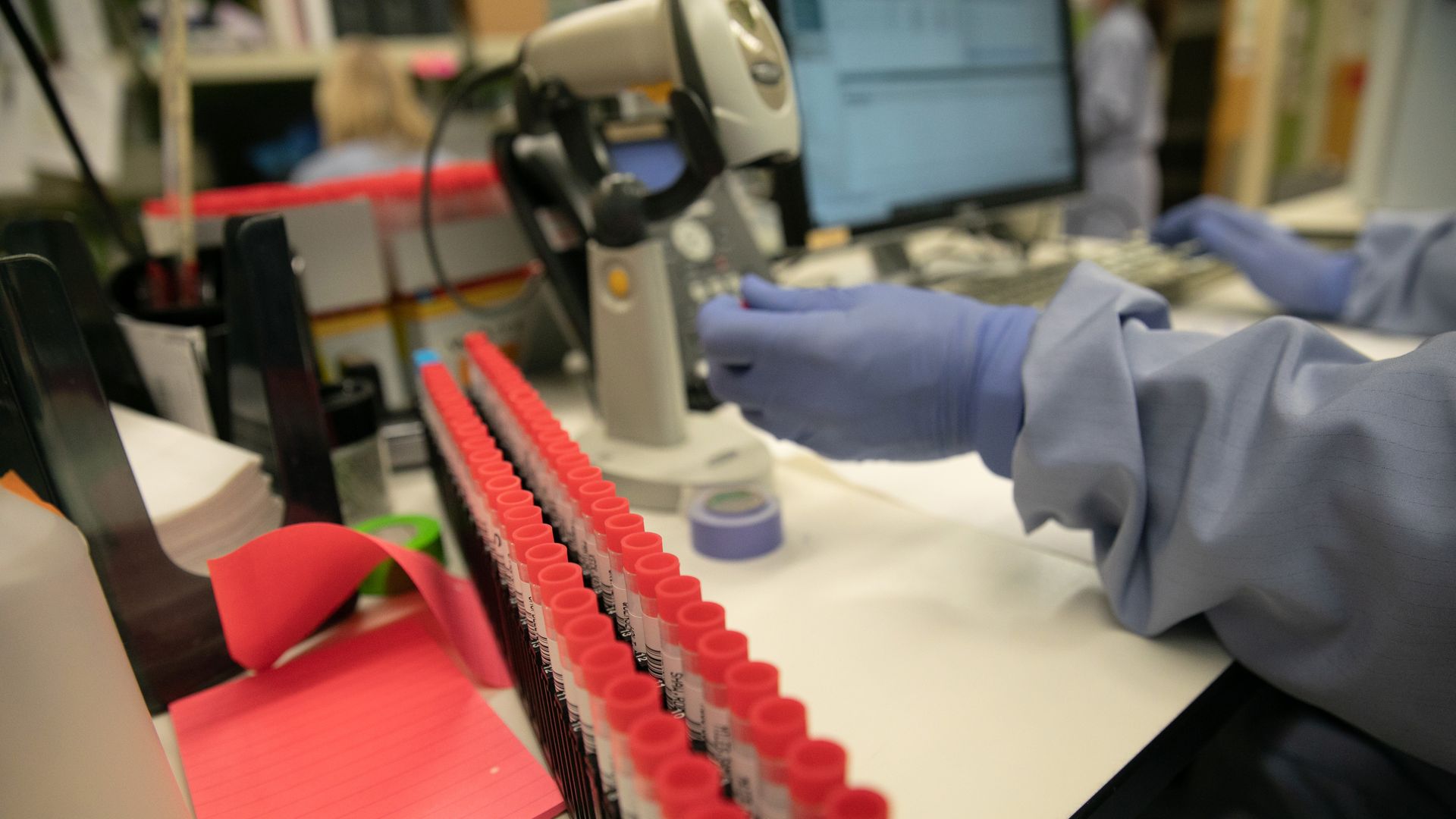 A medical Laboratory scientist tests vials for coronavirus at the University of Washington Medicine