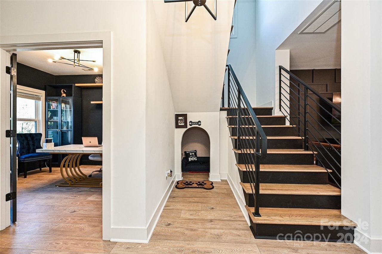 small nook next to the stairs with dog bed