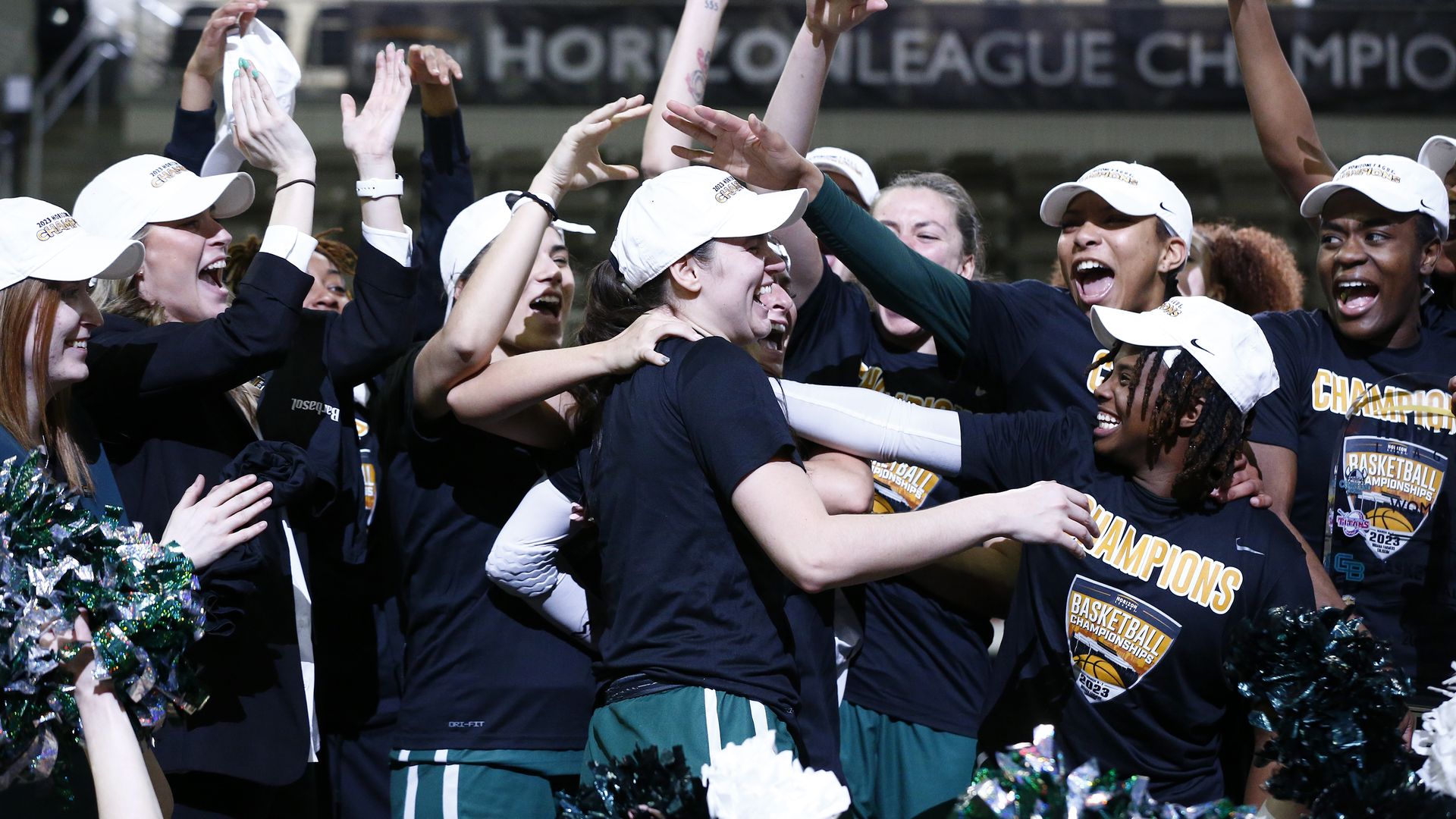 Members of the CSU women's basketball team celebrating, with white championship hats on