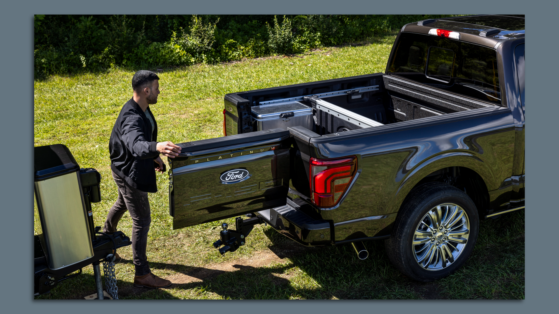 Image of a man opening the new swing tailgate in a Ford F-150 pickup truck. 