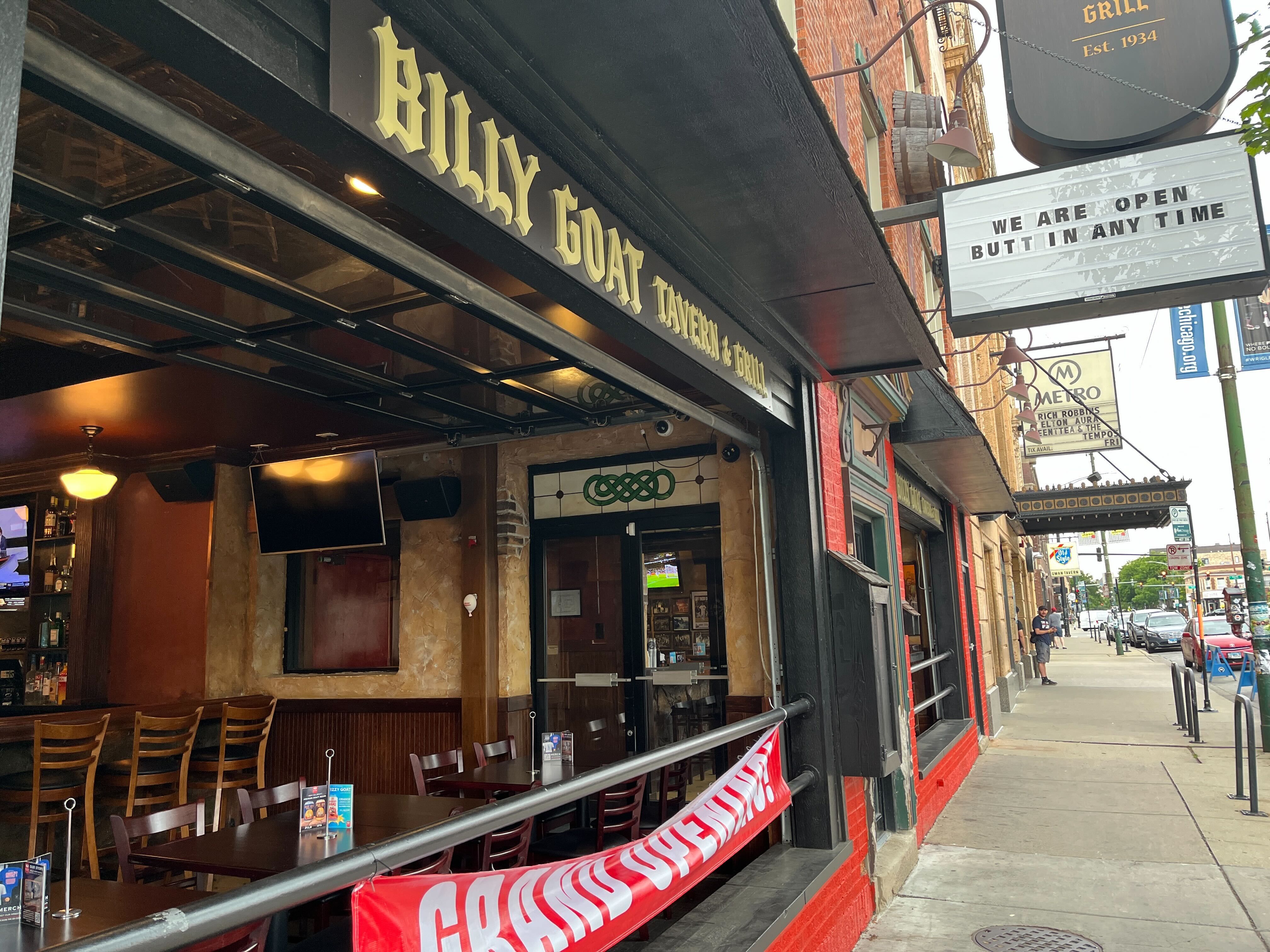 Photo of the front of a restaurant with a sign that says Grand Opening 