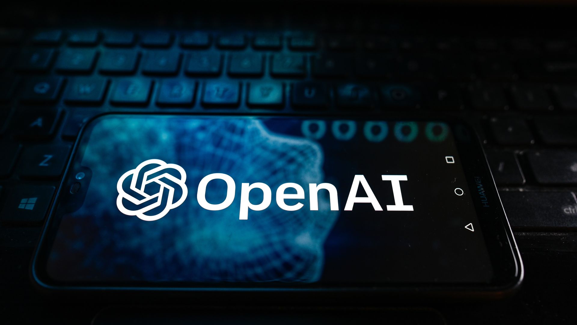 A photo illustration of the Open AI logo displayed on a smartphone.  In this photo illustration a Open AI logo is displayed on a smartphone. 