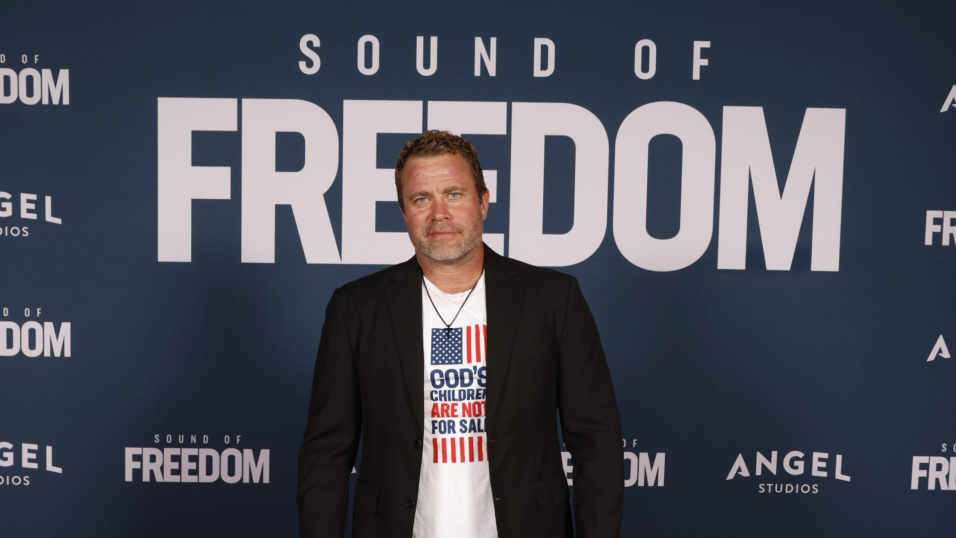 Tim Ballard stands in front of a screen that reads "Sound of Freedom."