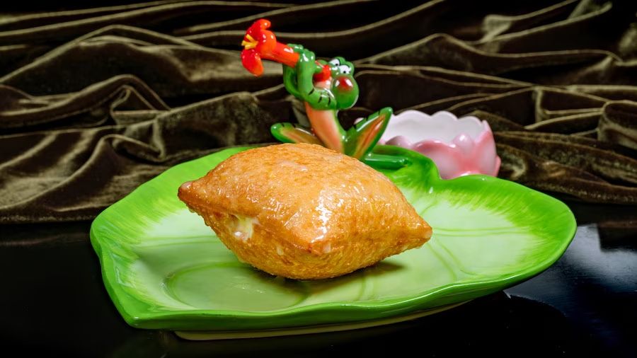 Photo shows a stuffed beignet on a lily pad plate.