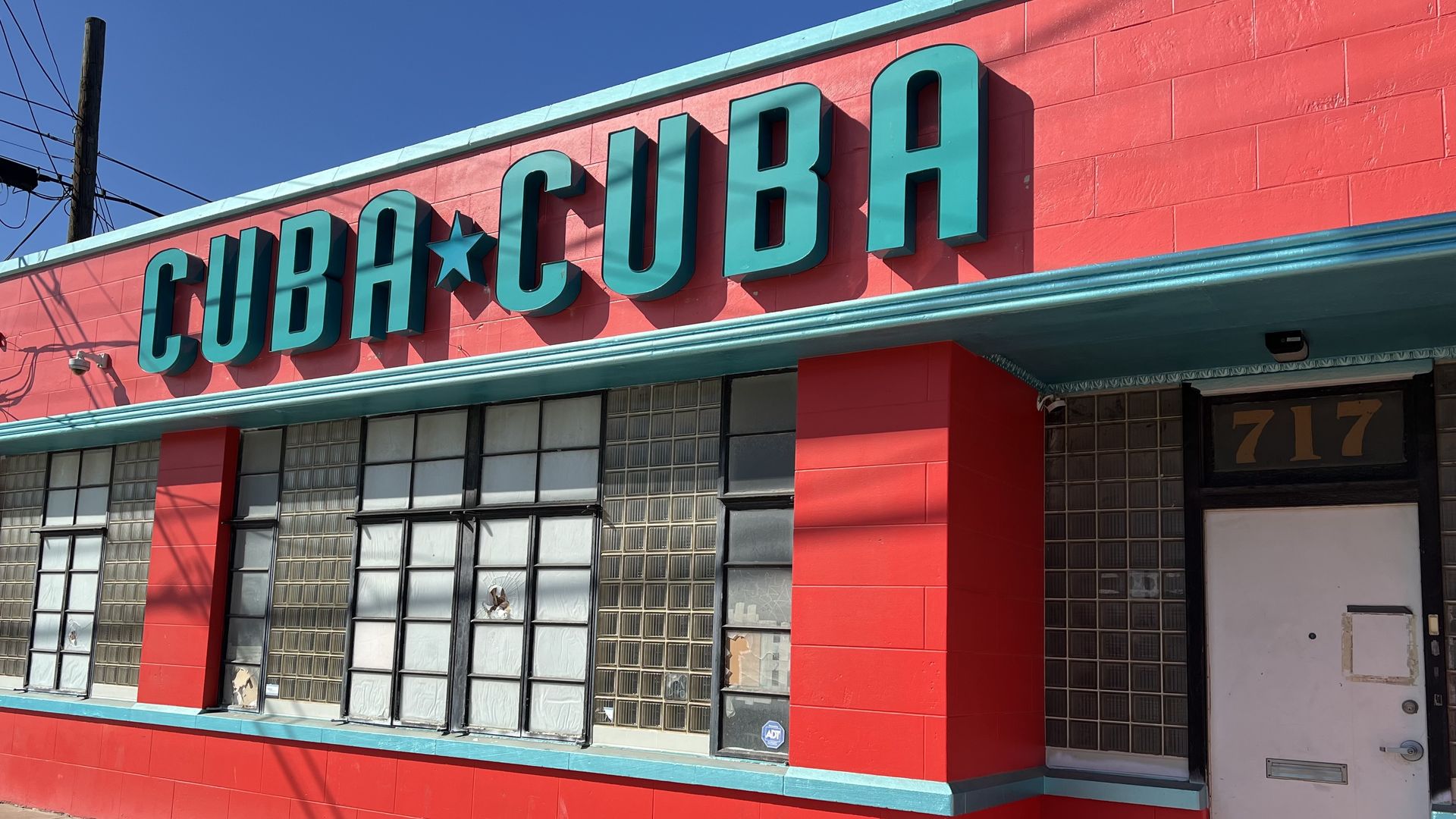 Cuba Cuba's exterior is bright red with a turquoise sign. 