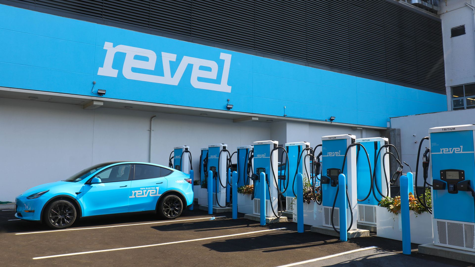 Image of Revel's Tesla Model Y plugged into a Revel charging hub in NY