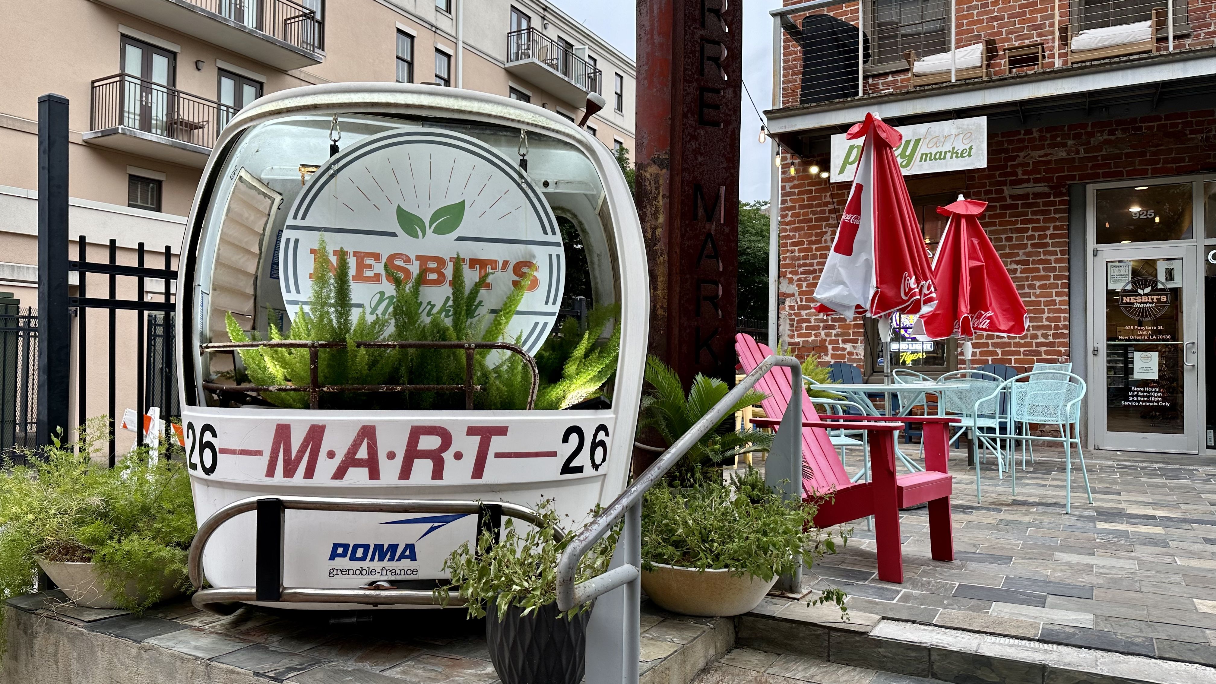 Photo shows a white gondola in front of Nesbit's Market in the Warehouse District.