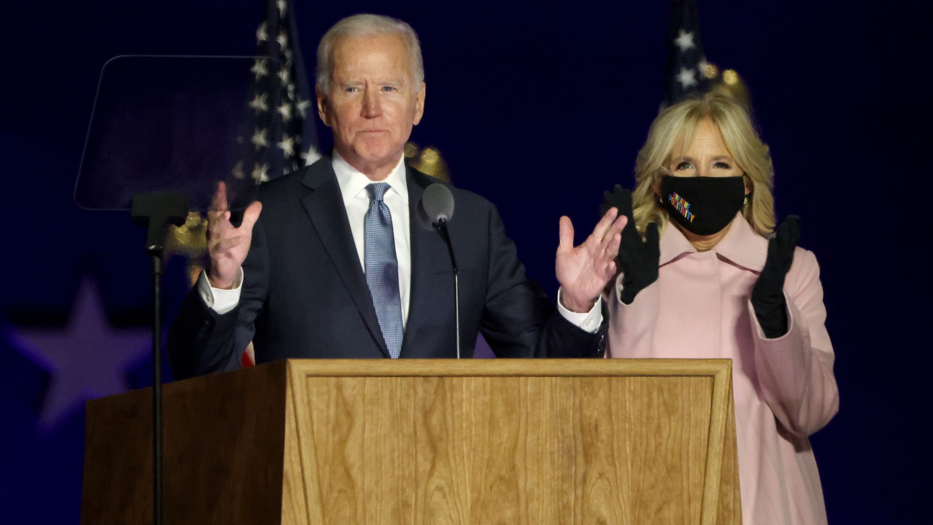 Picture of Joe Biden and his wife, Dr. Jill Biden, in front of a podium.